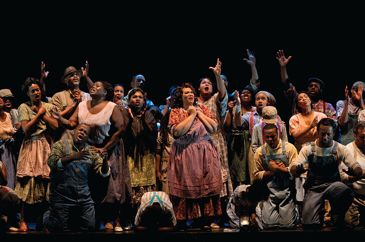 Photo: The residents of Catfish Row pray for safety from the approaching hurricane in our 2012 production of Porgy and Bess . Photo by Philip Groshong.