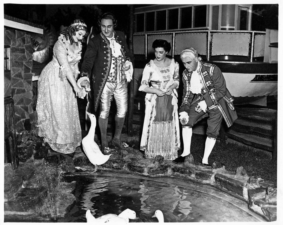  During the years Cincinnati Opera performed at the Cincinnati Zoo, interaction with—an interruption by—the Zoo’s primary residents was a frequent occurrence. Here, the cast of the 1949 production of  Andrea Chenier  gets acquainted with a feathered 