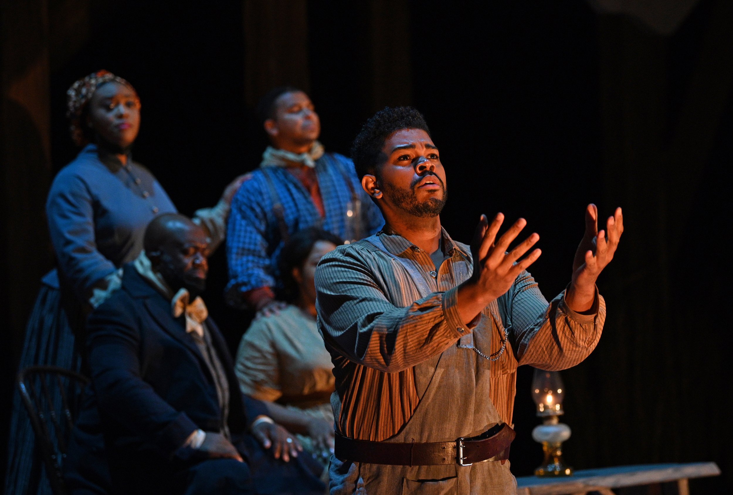  Congregants gather at a Watch Night service: (foreground) Phillip Bullock, (rear clockwise from top left) Zoie Reams, Victor Ryan Robertson, Amber Monroe, Earl Hazell. Photo by Philip Groshong. 