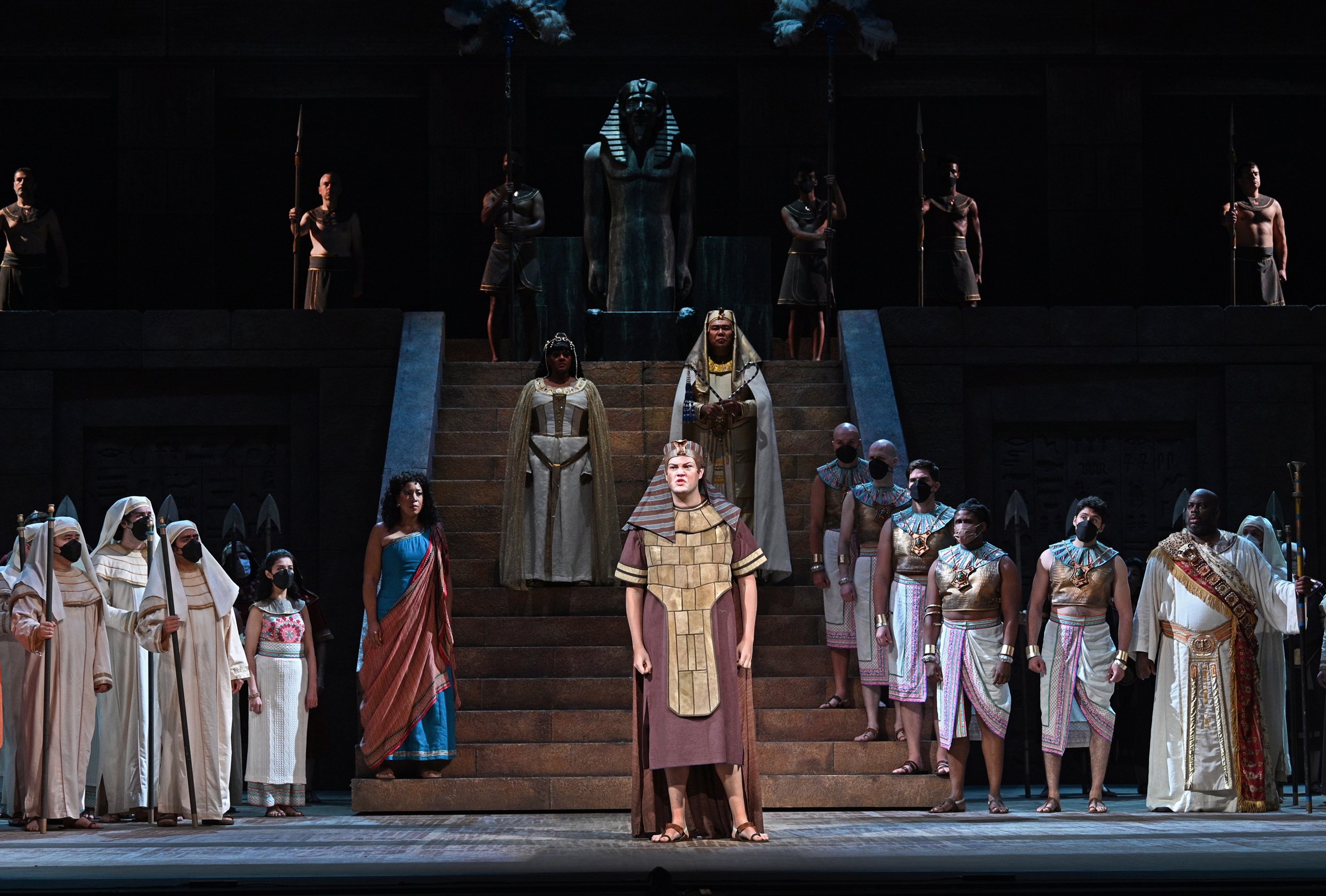  Houston Tyrrell as the Messenger (foreground) with Mary Elizabeth Williams as Aida, Tichina Vaughn as Amneris, and Peixin Chen as the King of Egypt. Photo by Philip Groshong. 