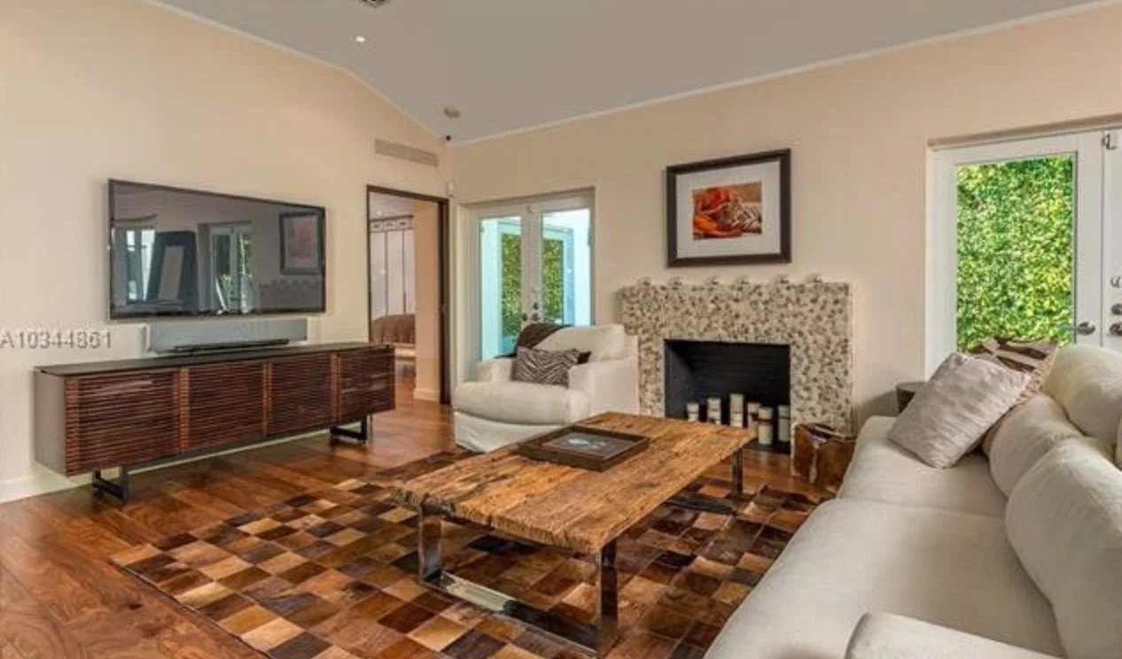 Venetian Island living room before remodeling with dated fireplace finishes and disconnected furniture layout