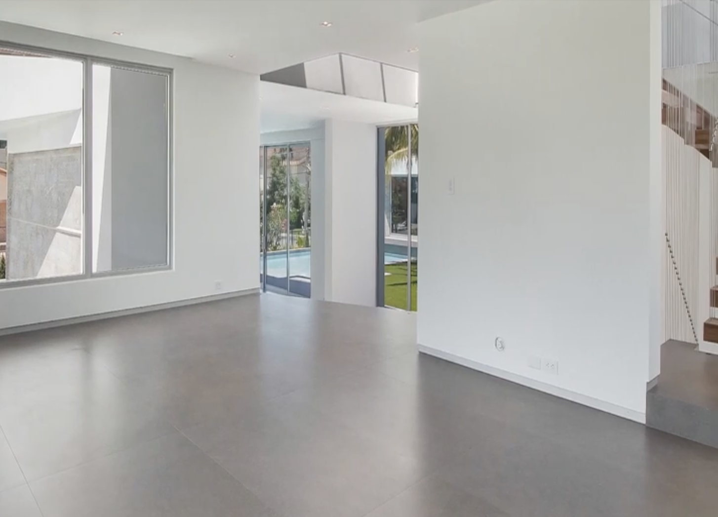 Family room interior before renovation in Hibiscus Island Miami Beach luxury residence with open layout and surrounding floor to ceiling windows