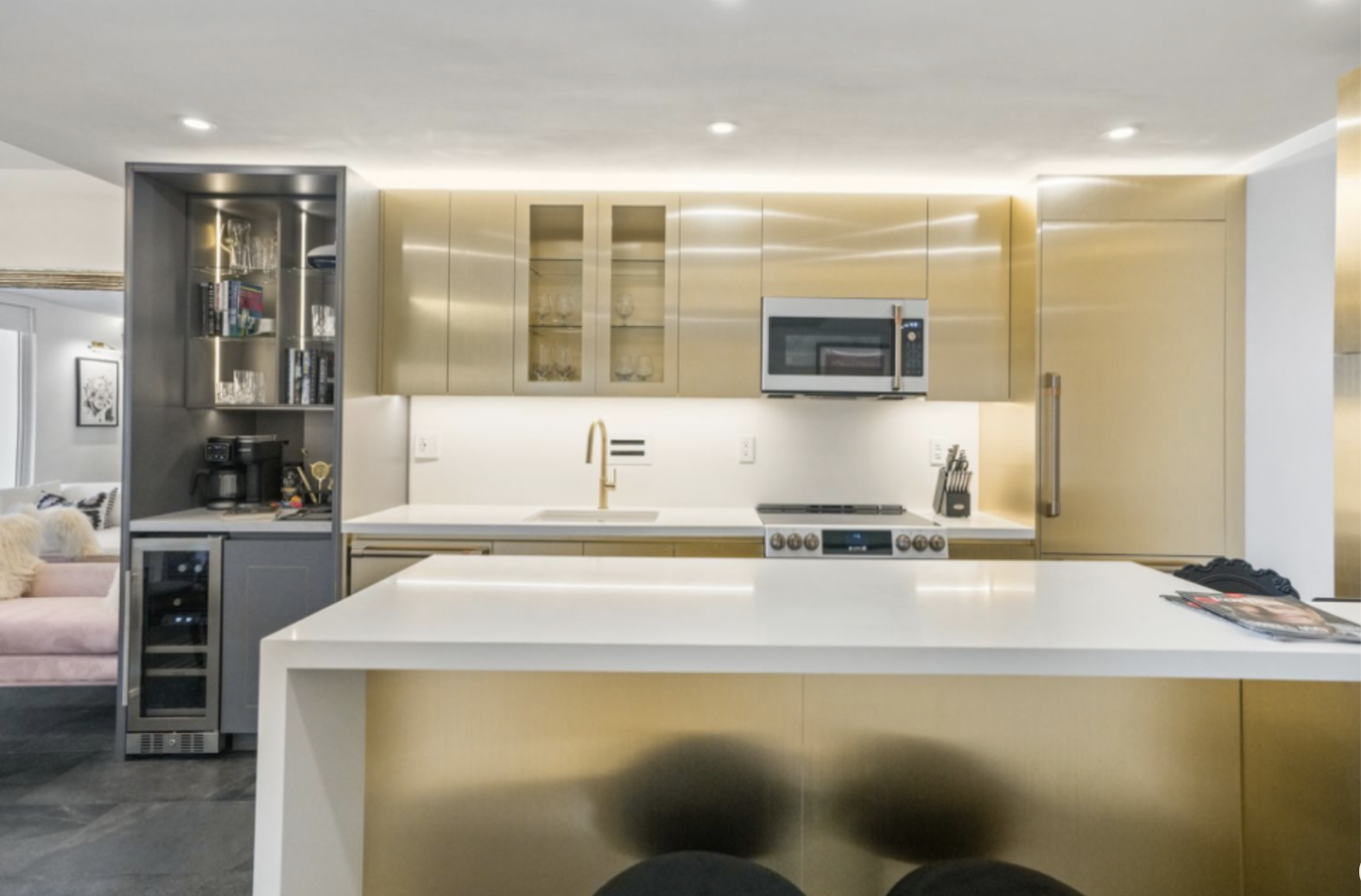 Miami Beach themed Airbnb kitchen and bar redesign with matte gold metallic laminate and charcoal cabinetry