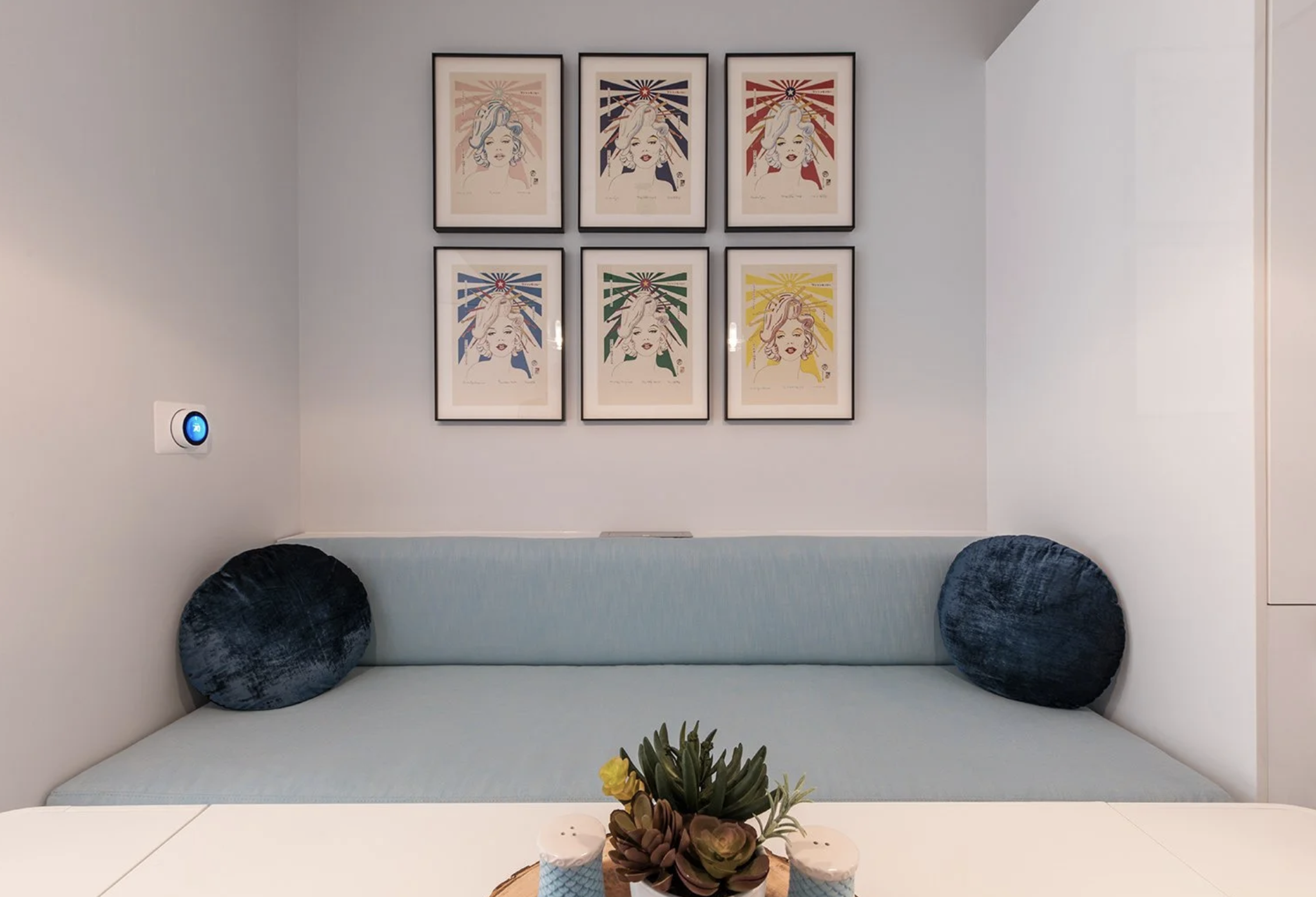 An innovative multi functional small space design in Miami bayfront condo with custom banquette dining table home office cabinetry wine chiller and storage