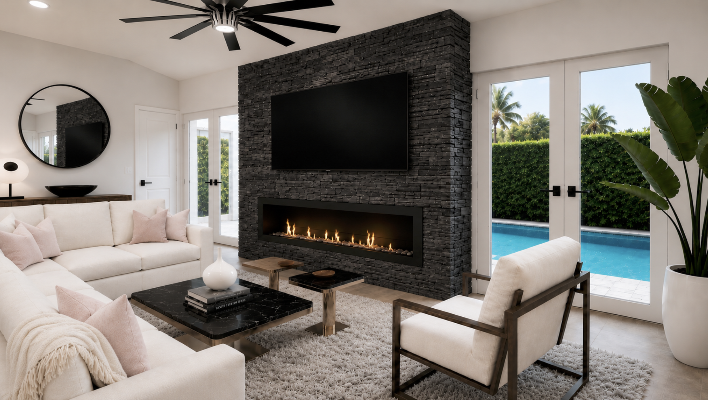 Luxury Venetian Islands Miami living room remodel featuring a charcoal lava ledger stone media wall, linear fireplace, bespoke furnishings, blush cashmere accents, and pool views through floor-to-ceiling glass.