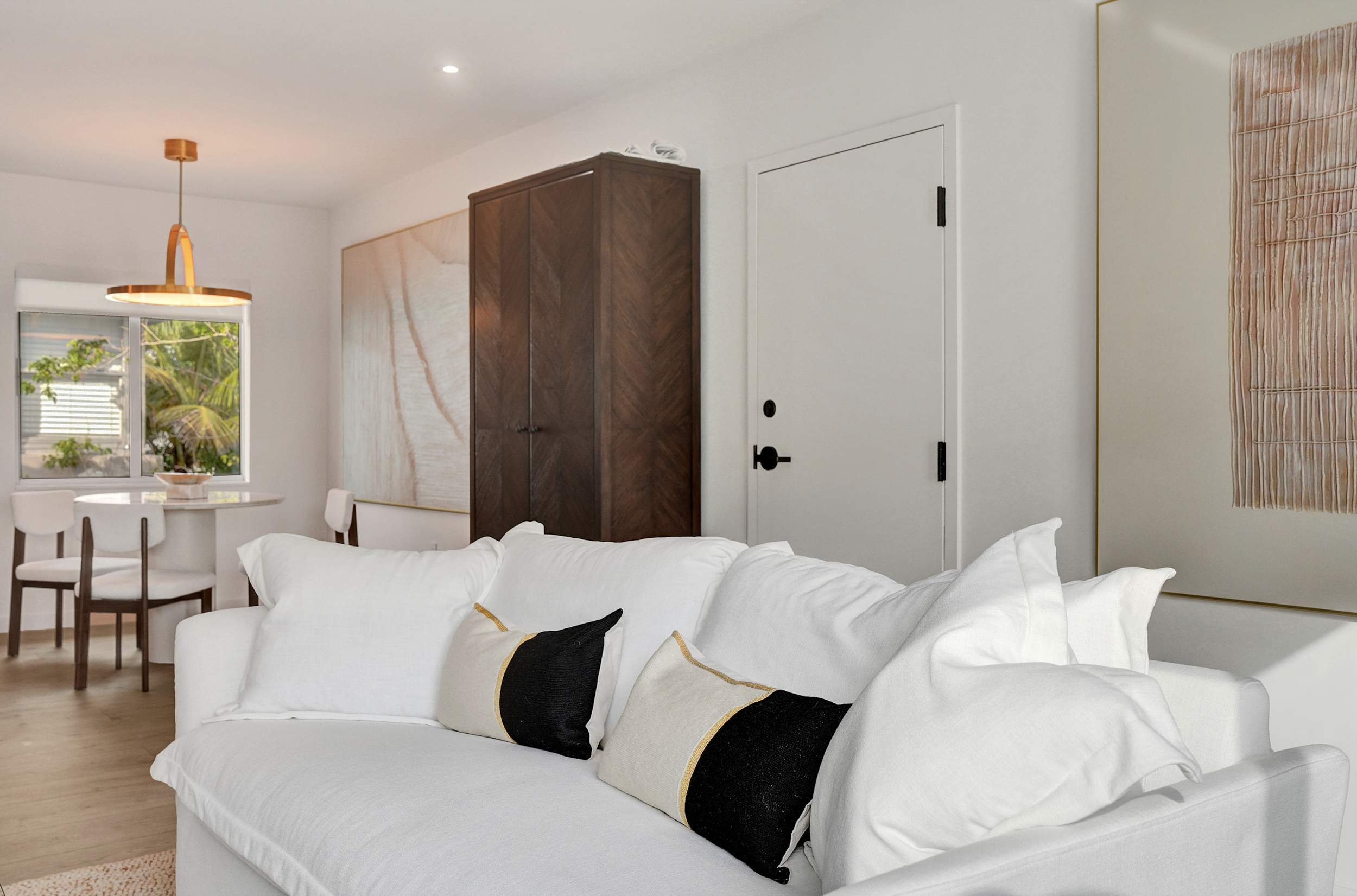 Organic coastal living room design in a Miami Beach condominium remodel by Exclusively To Design