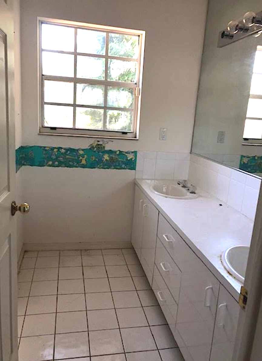 Coconut Grove guest bathroom before renovation with outdated tile, vanity, and tub surround