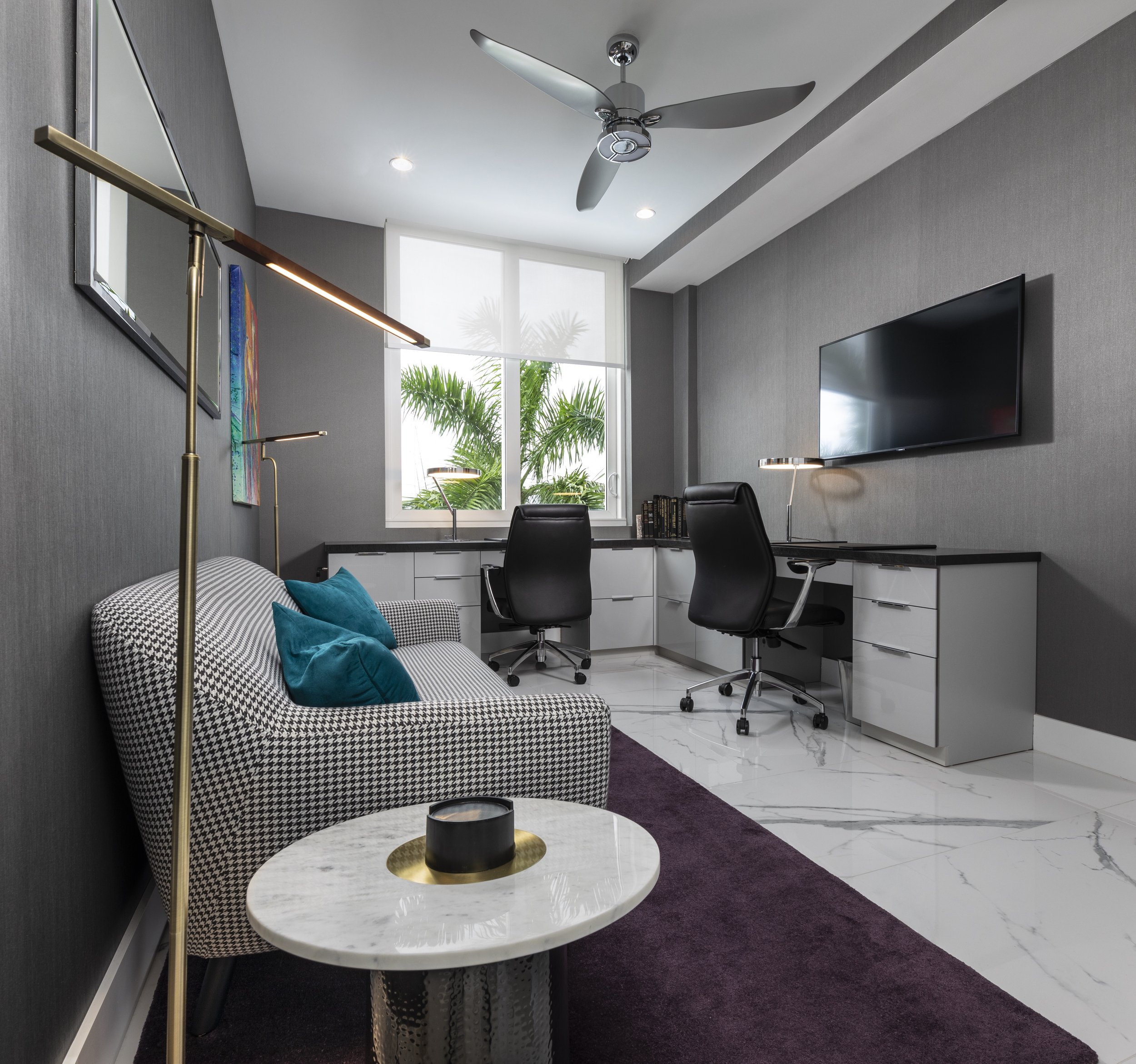 Luxury executive home office with custom corner desk, integrated workspace, menswear-inspired wallcovering, and contemporary furnishings in a Fort Lauderdale waterfront penthouse.