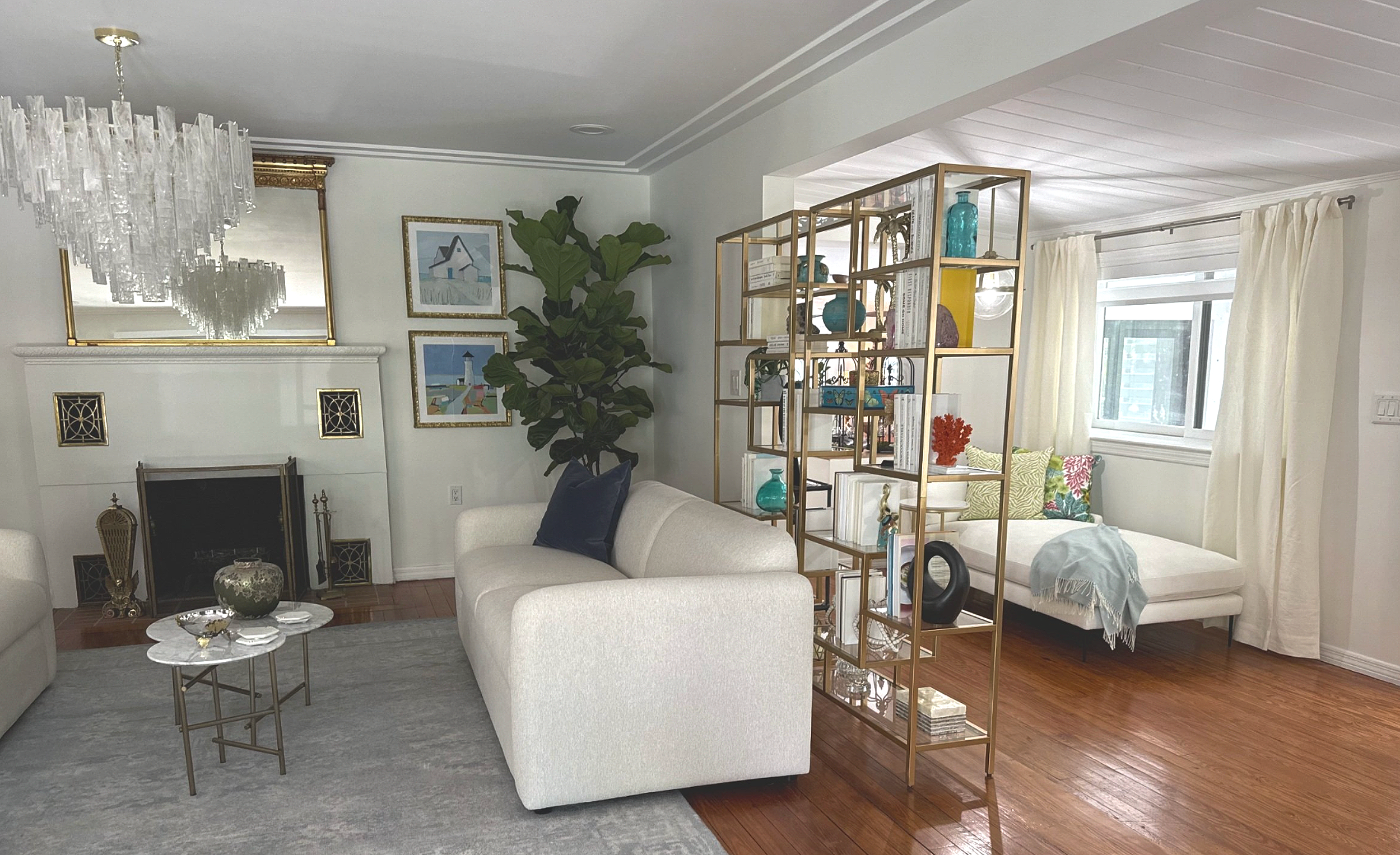 Coral Gables living room renovation with adjacent sunroomsoft seating, decorative shelving, and cohesive neutral finishes