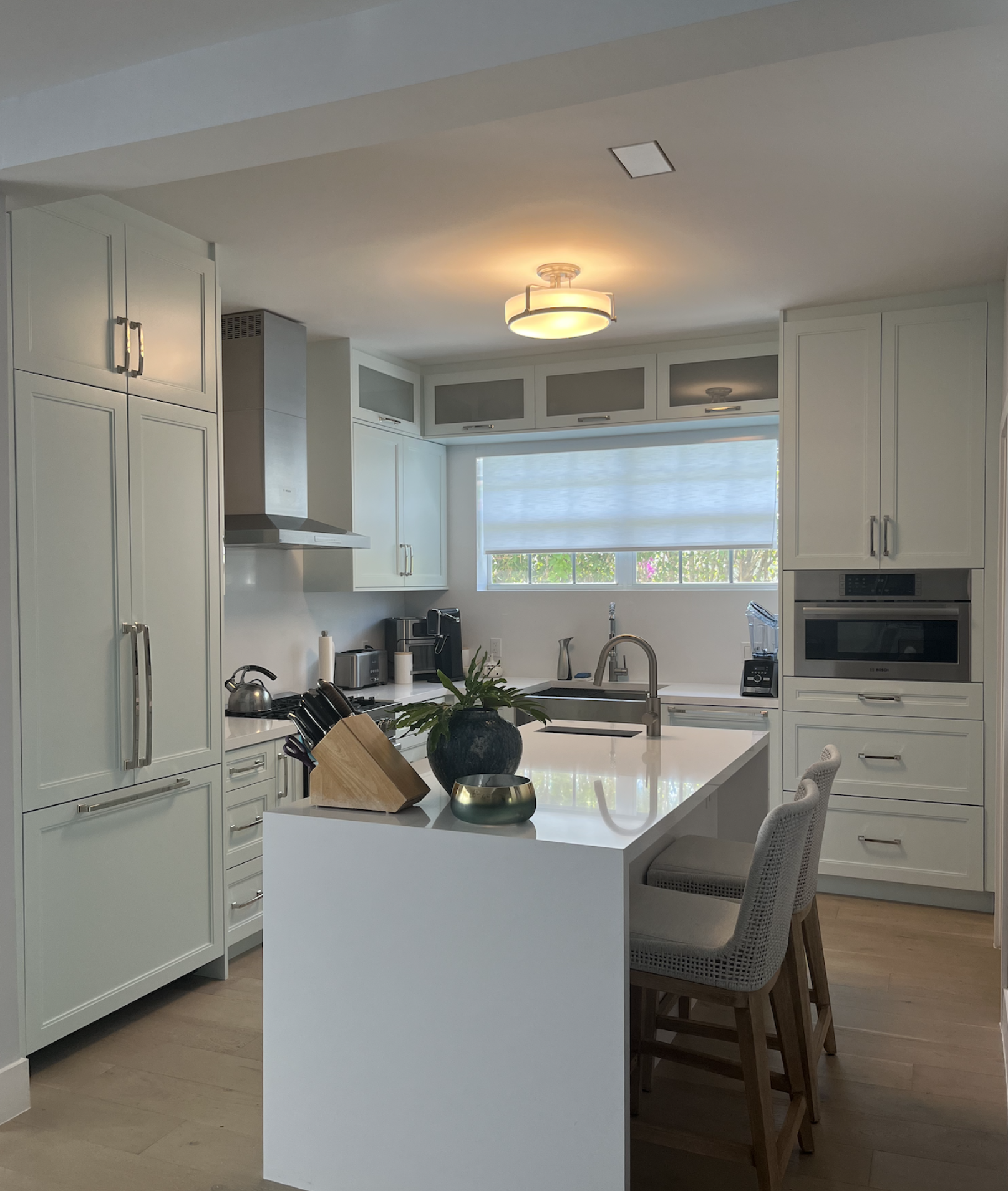 Organic coastal kitchen and dining area with decorative wood ceiling, custom skylight and herb garden, integrated kitchen design and open dining concept