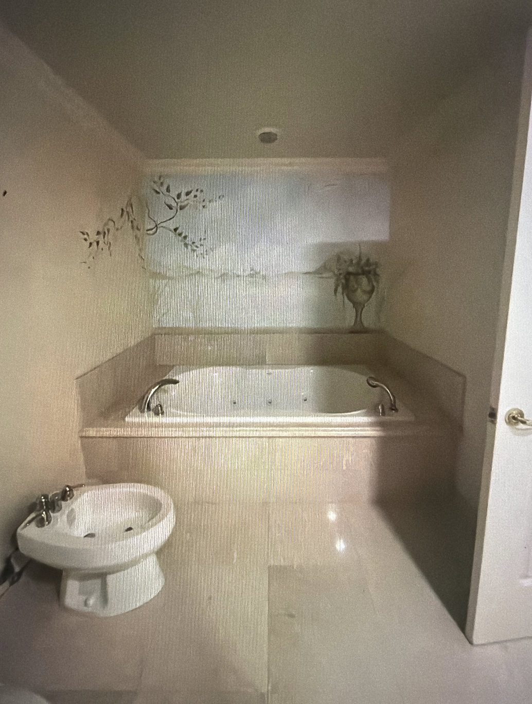 Before Hillsboro Beach condominium primary bathroom with oversized built-in whirlpool tub, beige tile finishes, cultured marble surround, and a compartmentalized layout before luxury renovation.