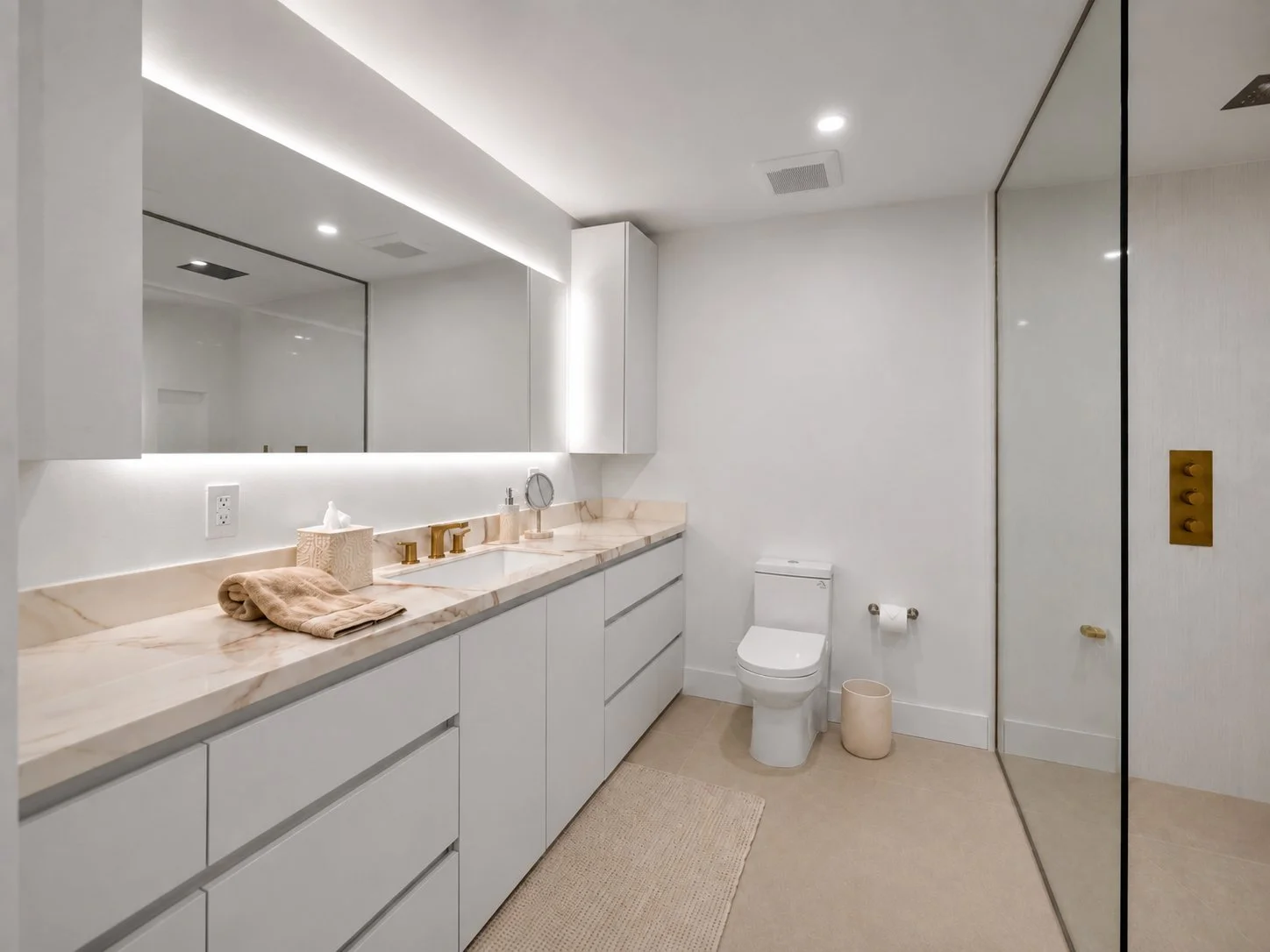 After Hillsboro Beach luxury primary bathroom remodel featuring a custom floating double vanity, integrated LED cove lighting, porcelain countertops, and a refined spa-inspired design.