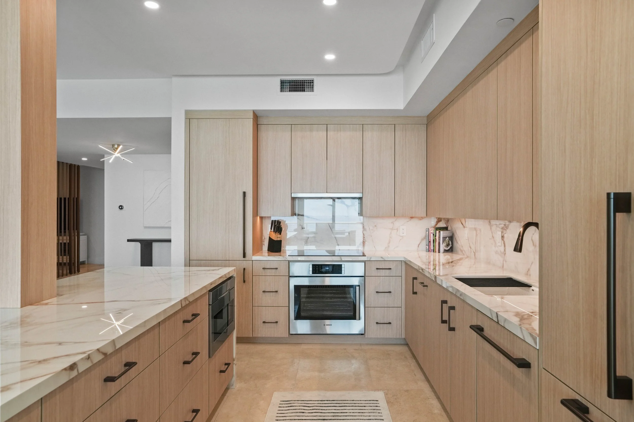 Open-concept Hillsboro Beach kitchen connecting the dining, living, and bar lounge areas.