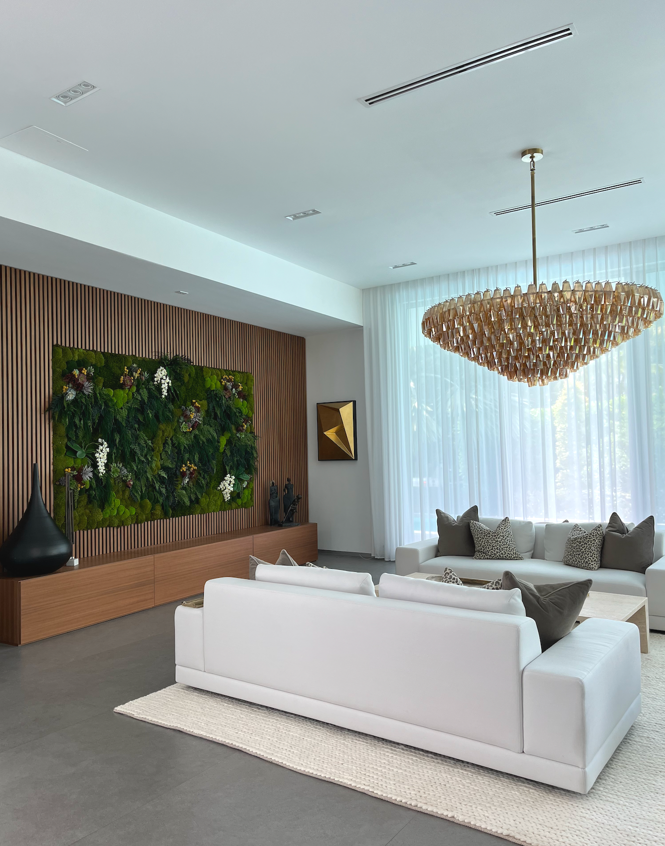 Modern living room with walnut slat wall and preserved green wall Hibiscus Island Miami Beach luxury interior design