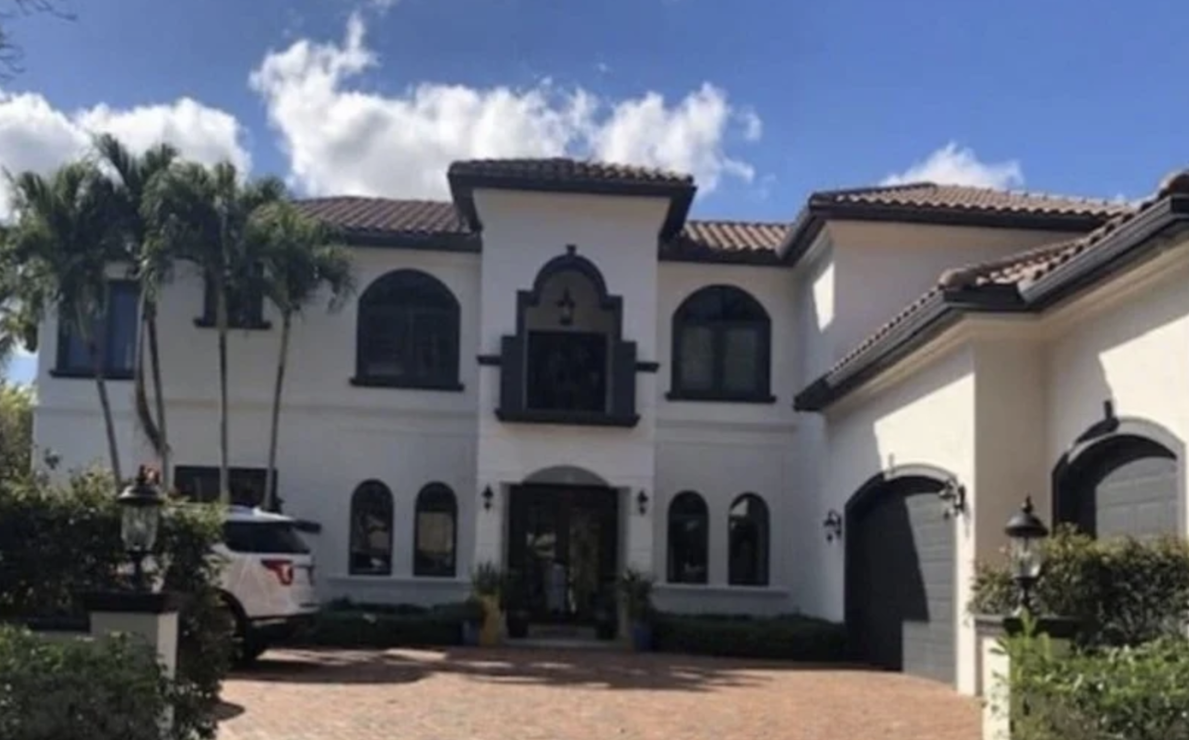 Luxury Boca Raton gated community residence exterior with Mediterranean architecture and landscaped driveway