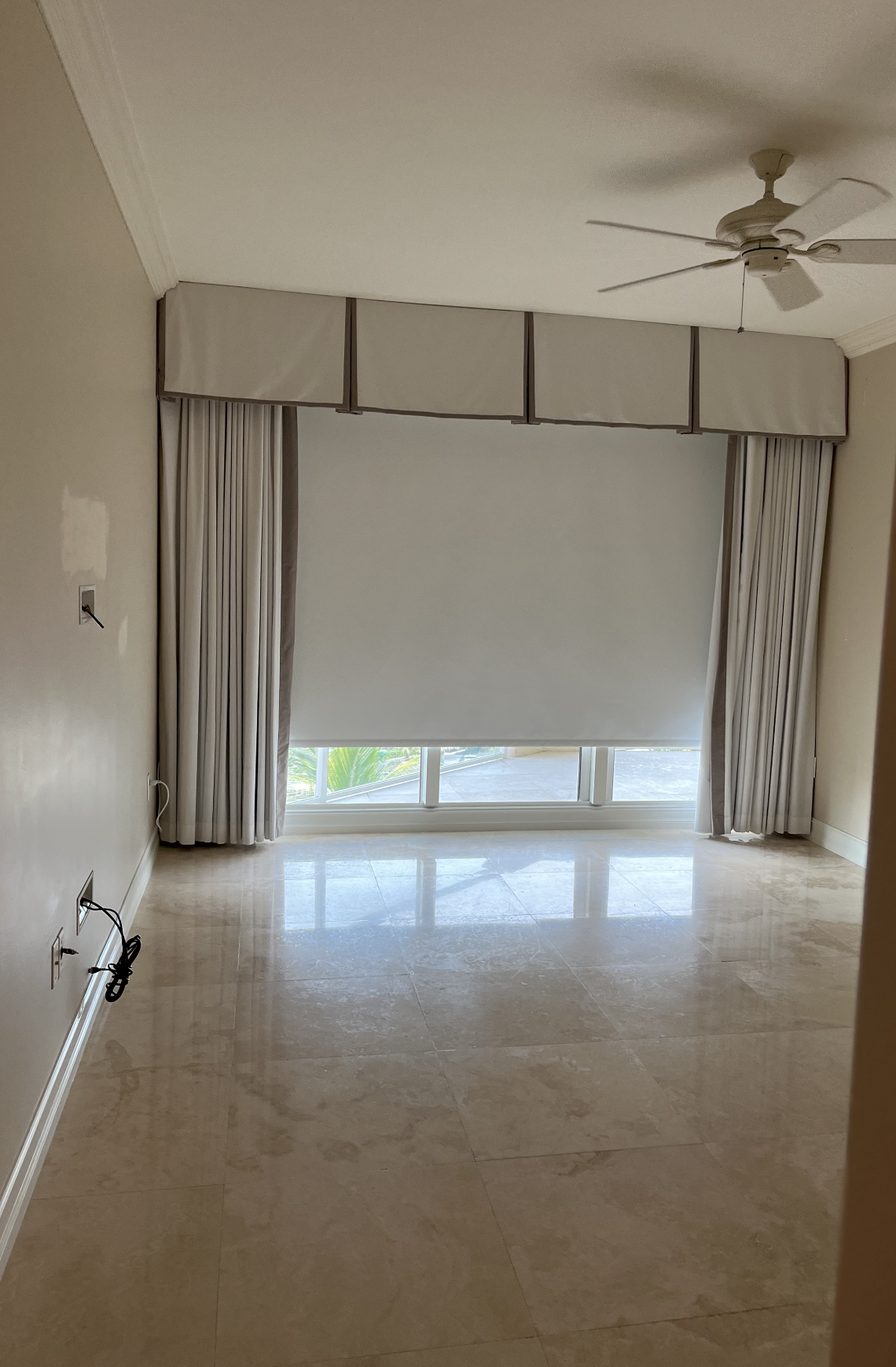 Before aqua coastal guest bedroom in a Hillsboro Beach condominium with empty marble floors, builder window treatments, and an unfinished layout before interior design renovation.