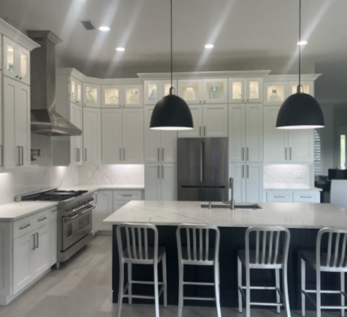 Lakewood Ranch kitchen remodel with custom white cabinetry, oversized island seating, modern pendant lighting, and open concept layout designed for entertaining