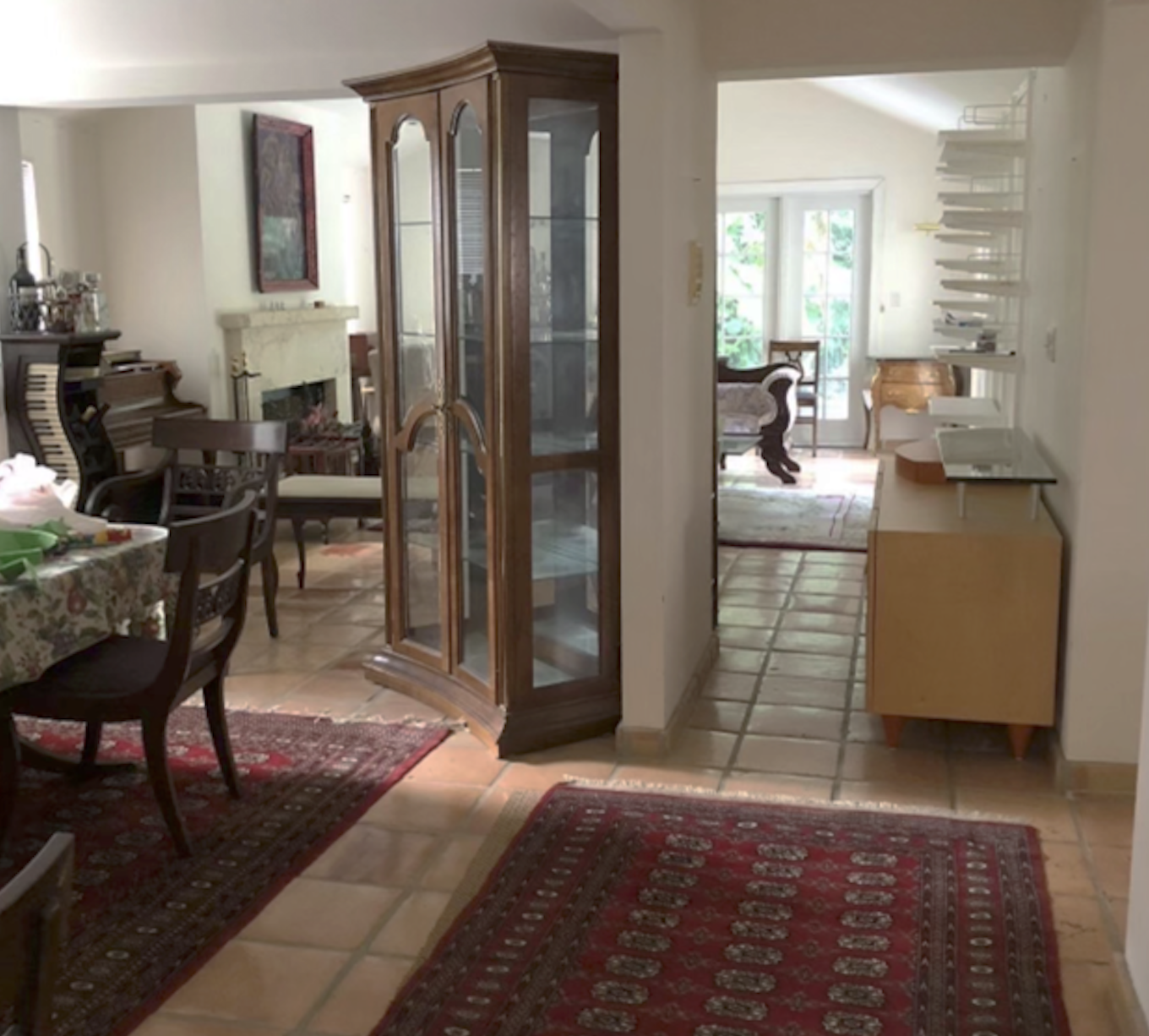 Coconut Grove dining and living room before remodeling with traditional layout with wall partition and dark wood furnishings