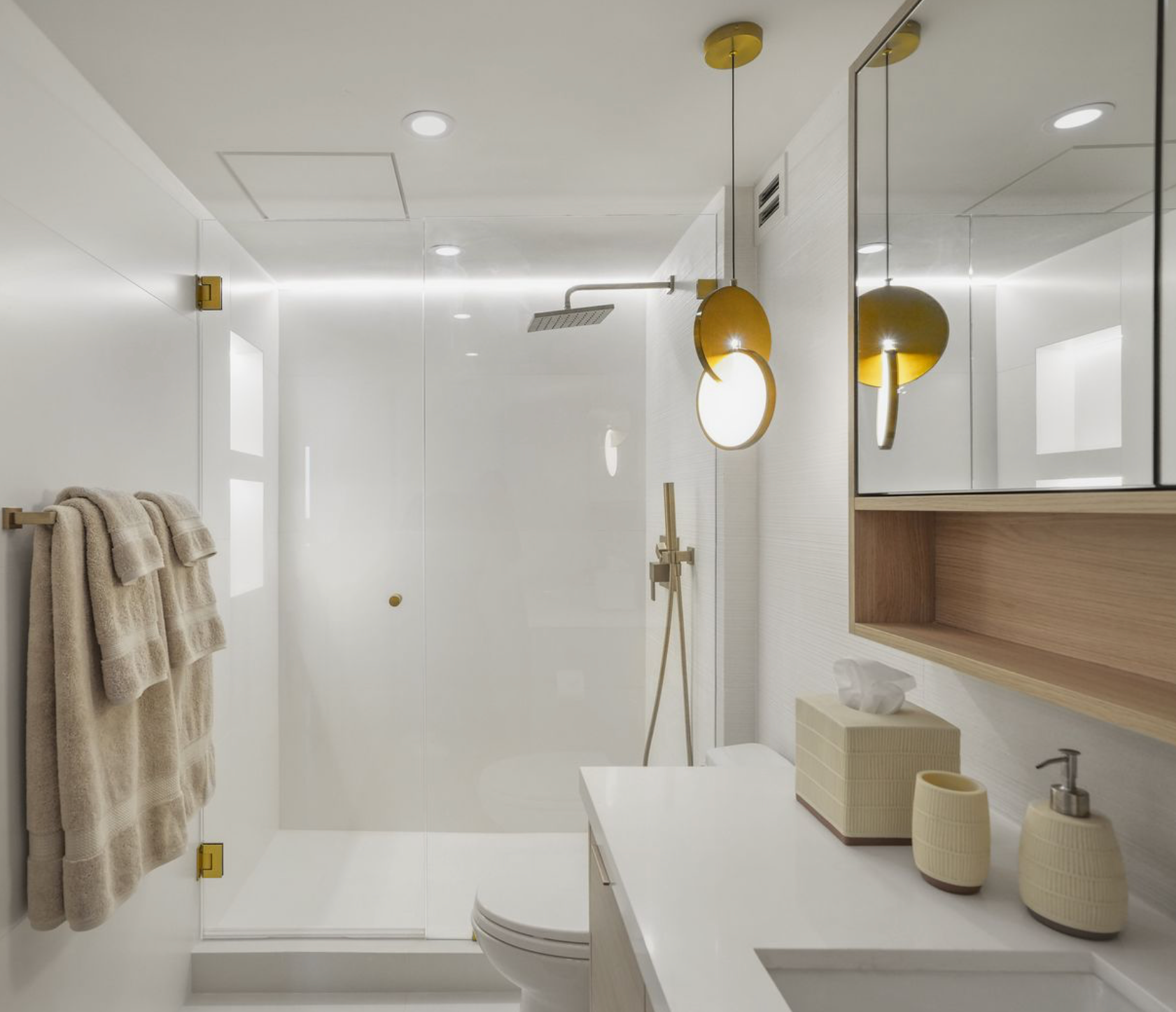 Spa-inspired bathroom design with a ribbed tile accent wall in an ivory satin finish with integrated LED lighting  and custom oak vanity and medicine cabinet.