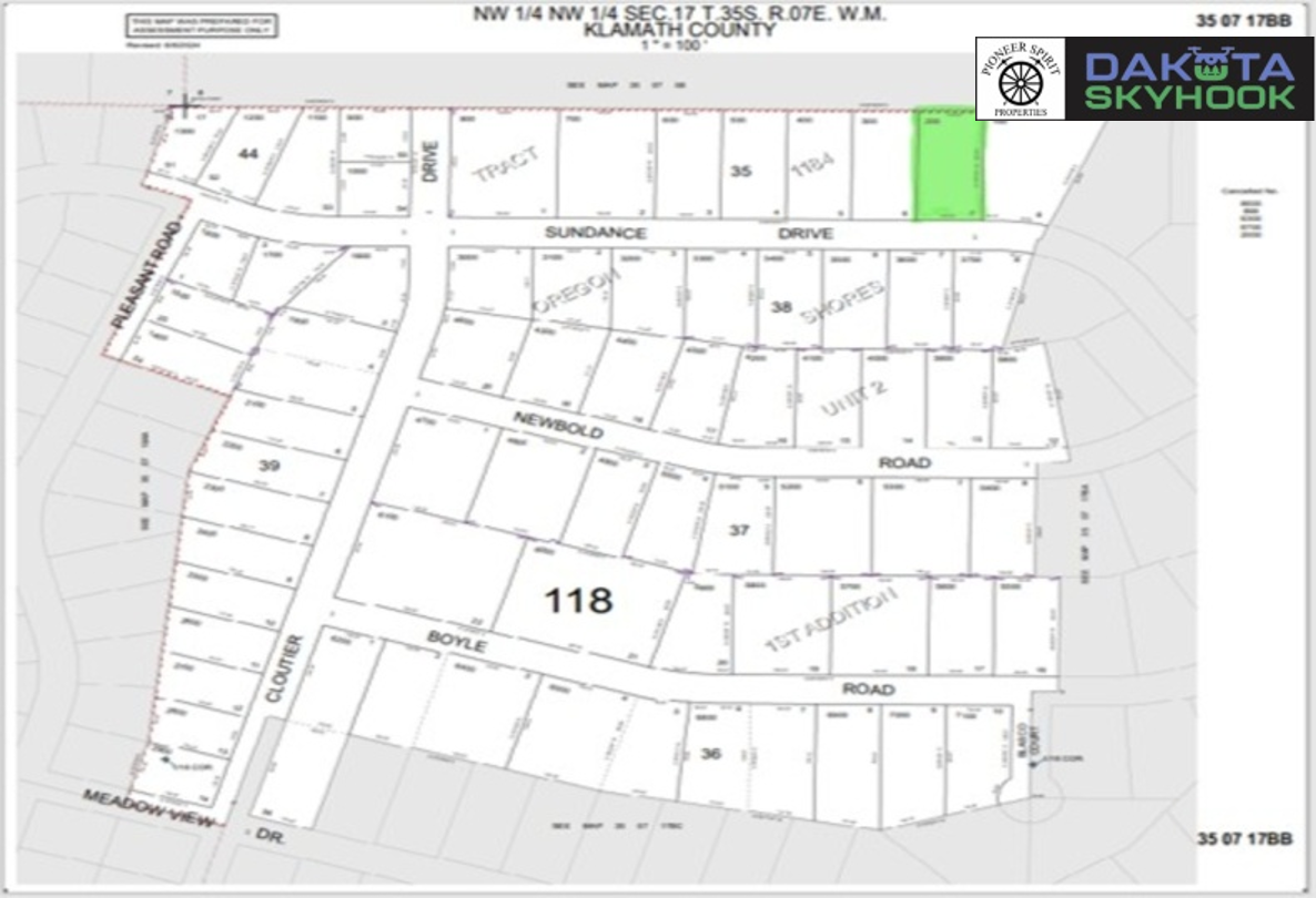 A map of land parcels in Klamath County, showing streets and lots, with a highlighted green lot in the upper right corner and a black and green logo in the upper right corner.