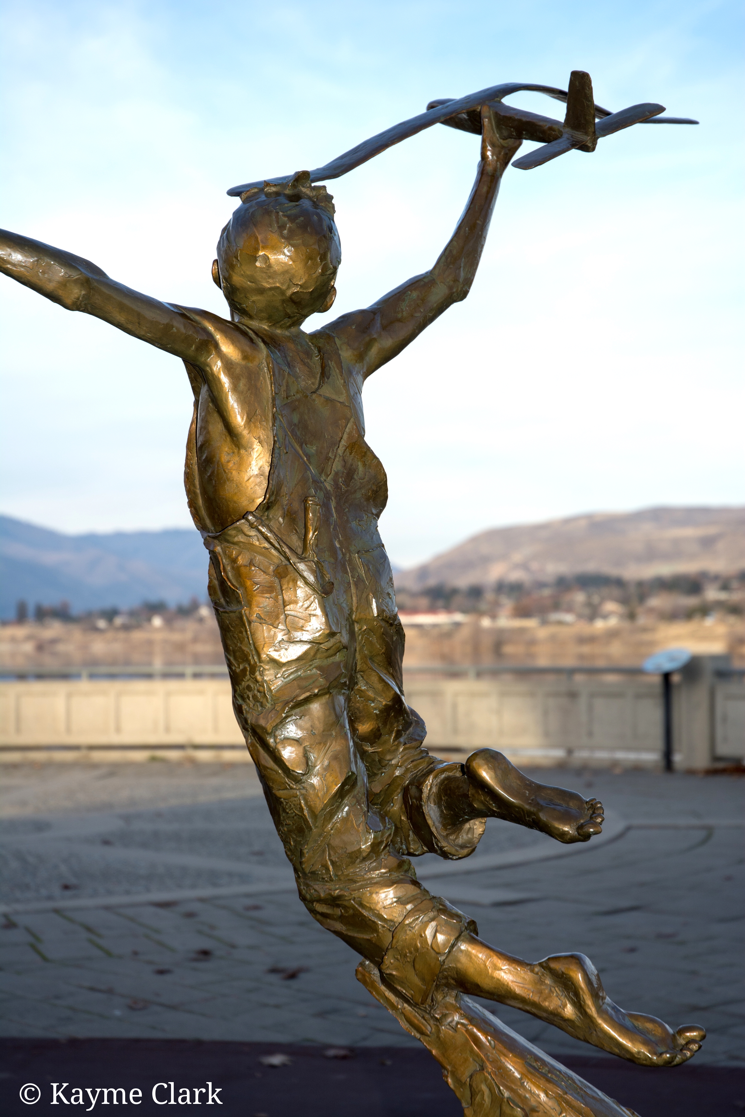 Boy with plane sculpture