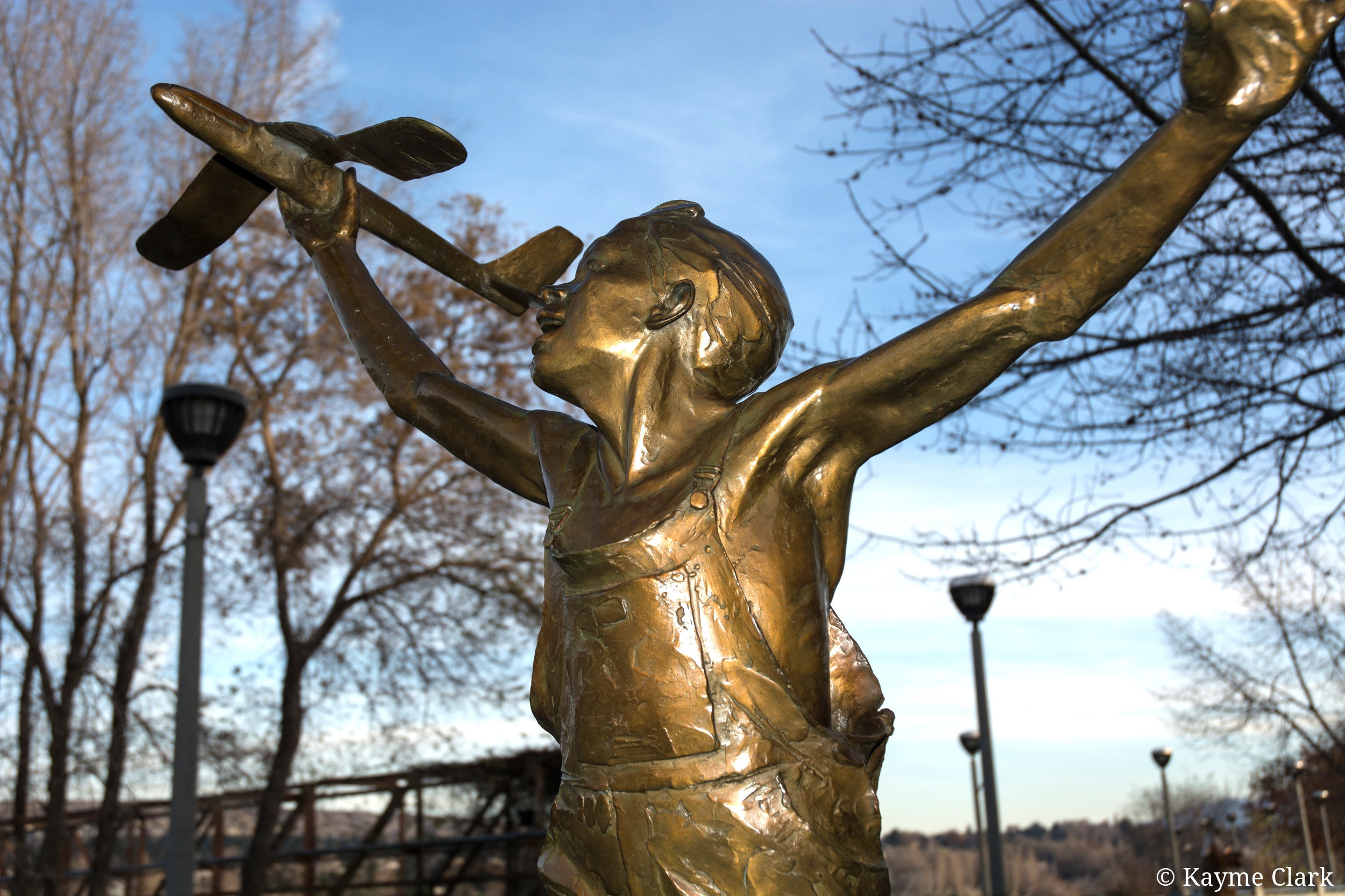 Boy with plane sculpture