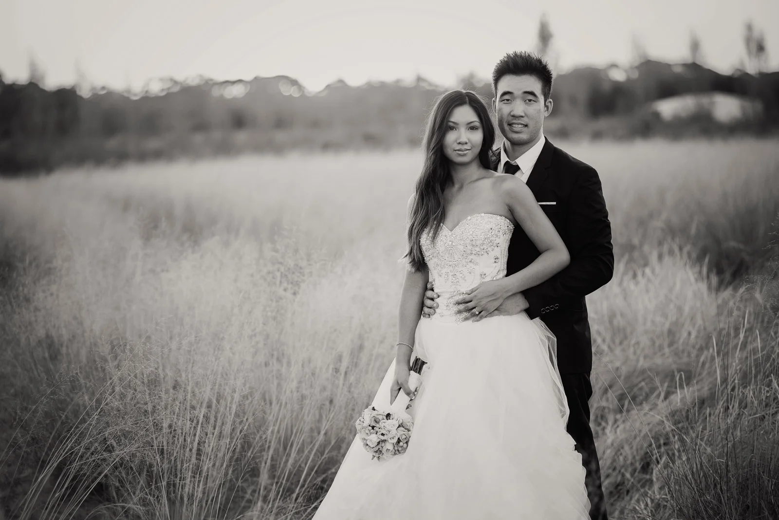 Beautiful wedding couple posing in a wheat field near Sittella Winery, B&W, Swan Valley.