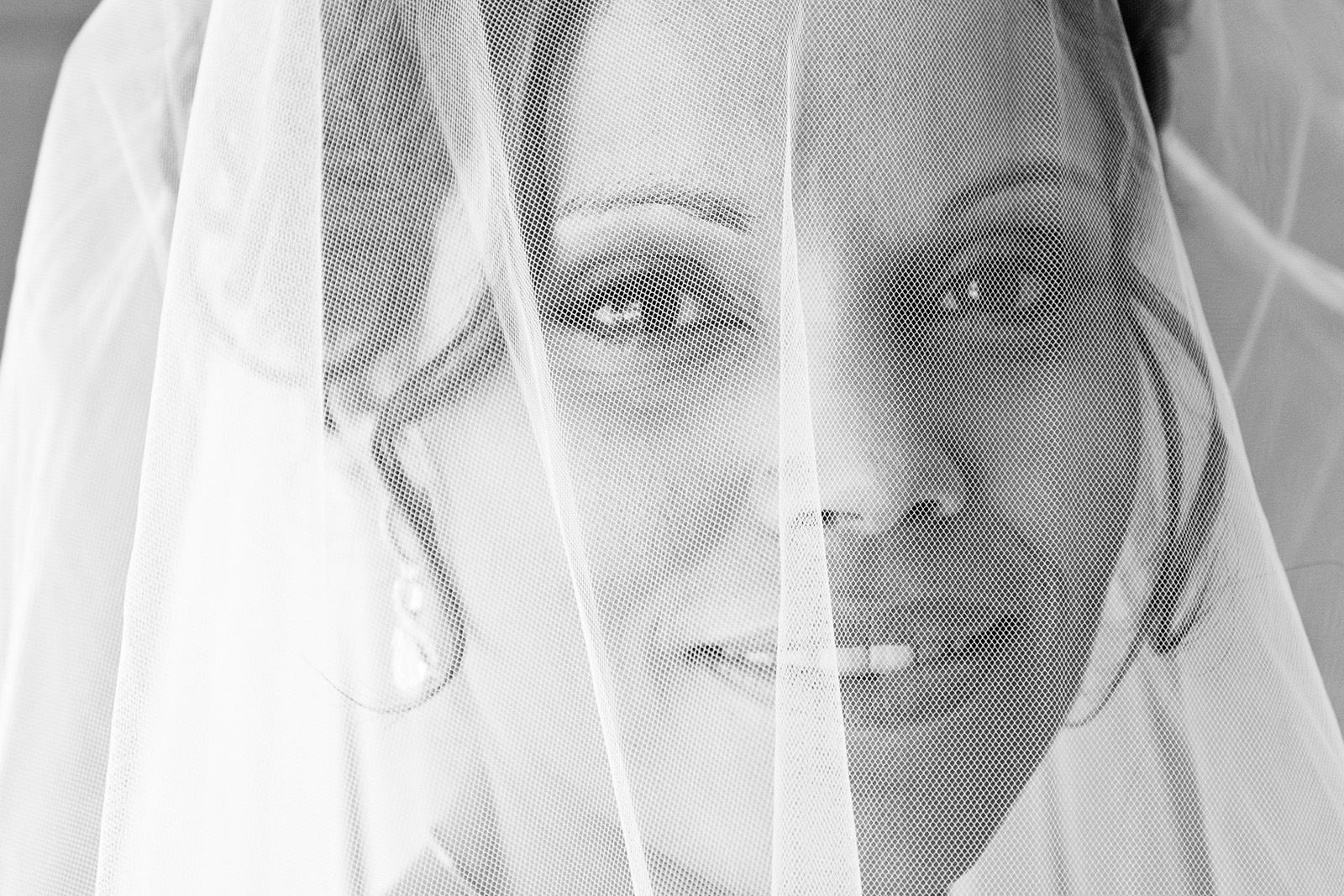 Close up portrait of a beautiful Aboriginal bride through her veil.