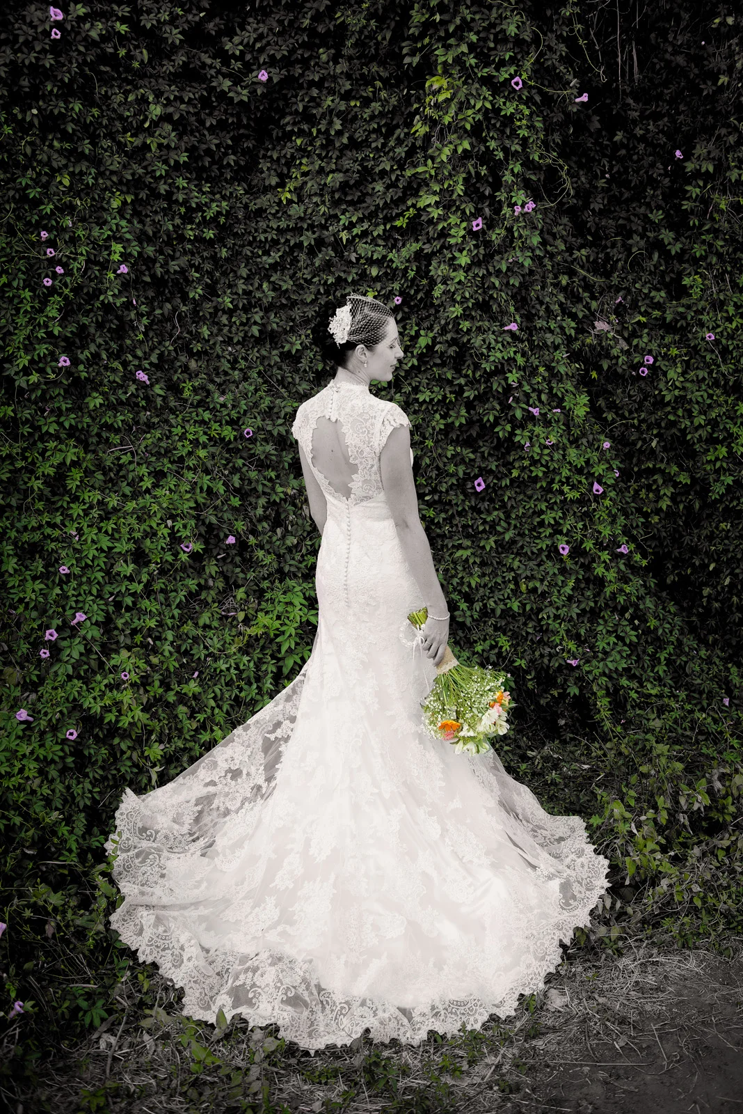back of the Bride facing green Ivy with purple flowers at Darlington Estate.
