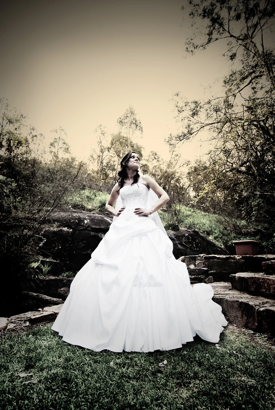bride with hands on hips looking up at sky at Araluen Botanic Park, Roleystone.