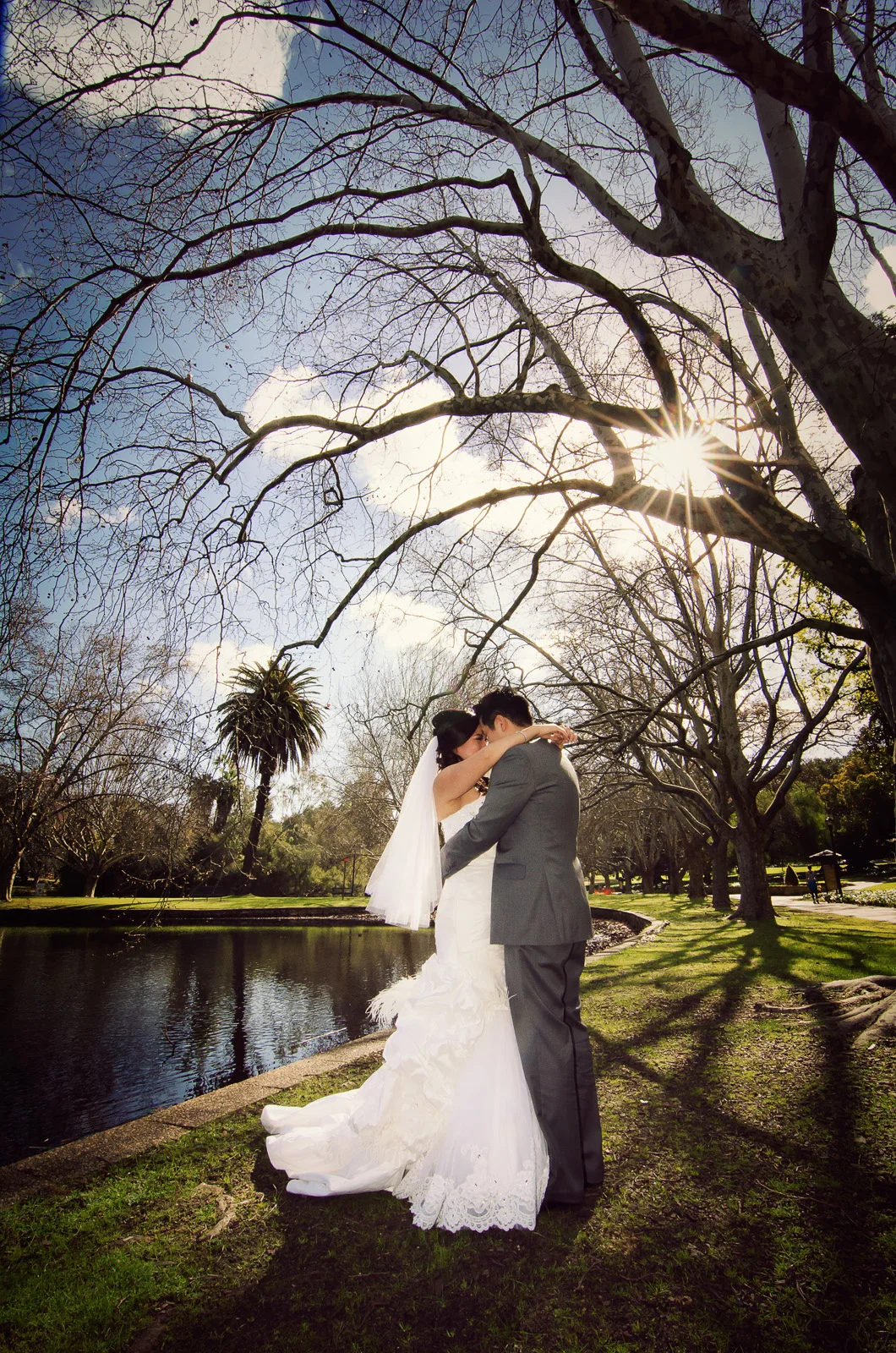 bride and groom's romantic embrace on a sunny day at Hyde Park, North Perth