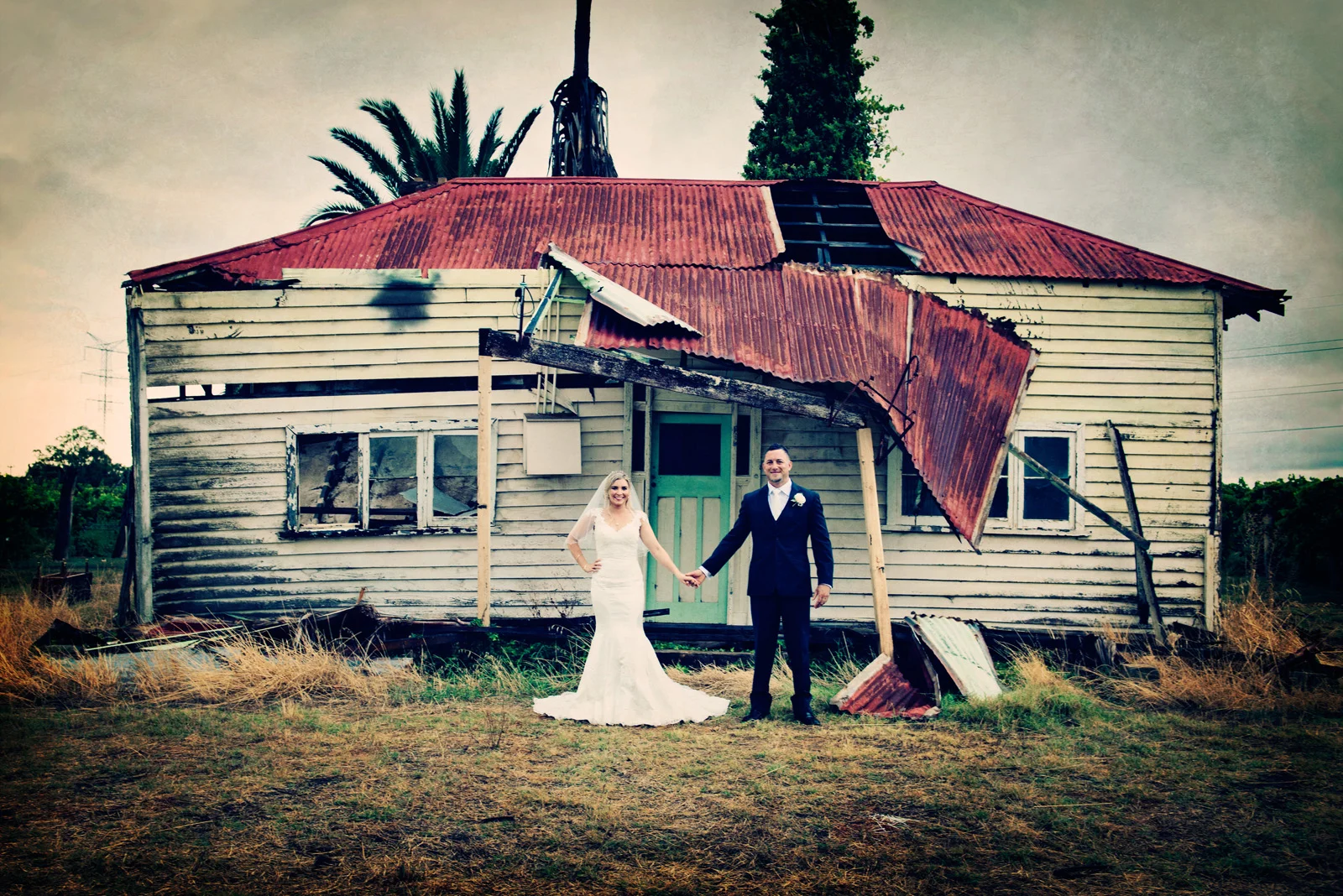 couple holding hands. Stormy day, old house in Swan Valley.