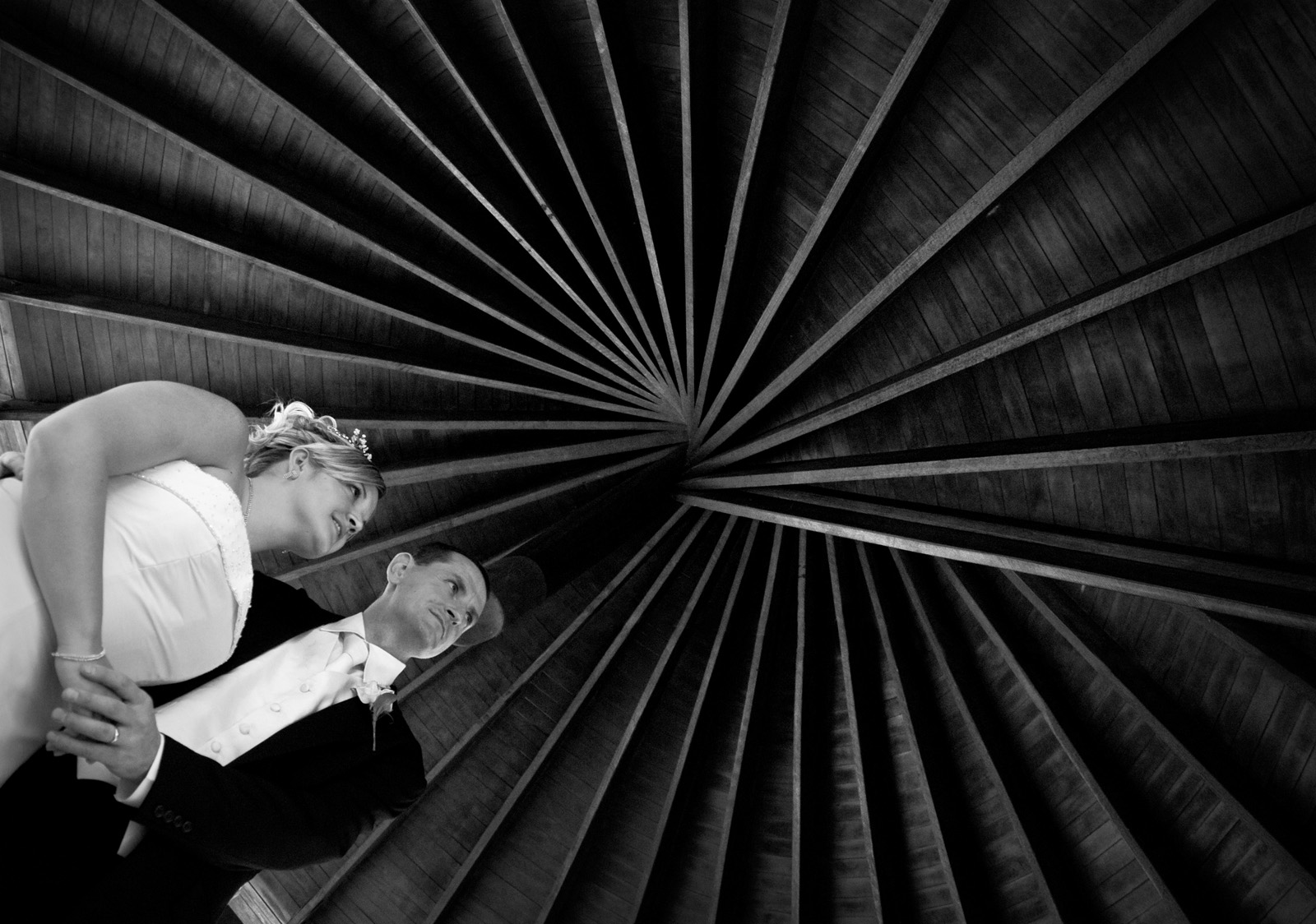 Bride and Groom posing under a rotunda roofs cool spiral pattern, Kings Park.