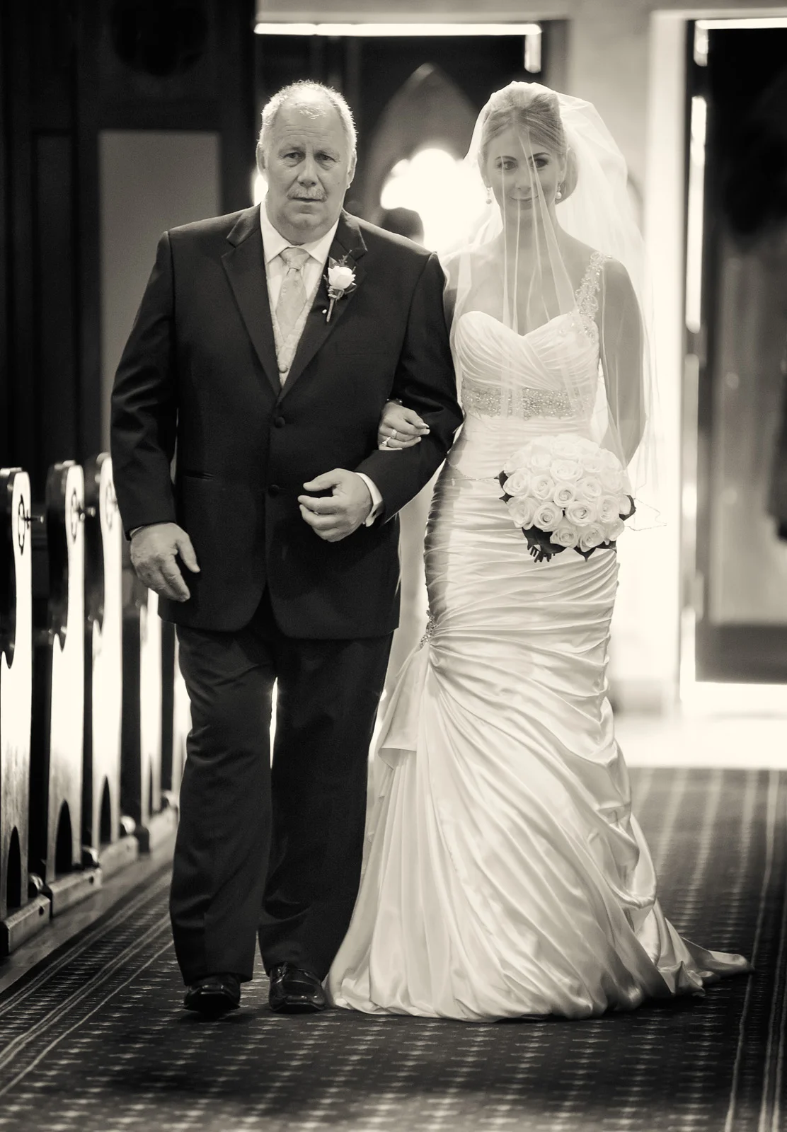 Proud Father walking the Bride down the aisle in a church