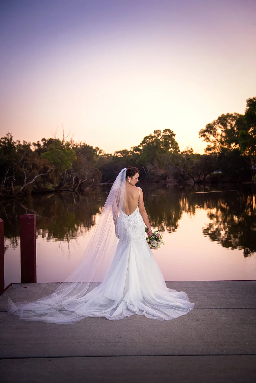 Back of the Brides dress on the Caversham Estate jetty at sunset