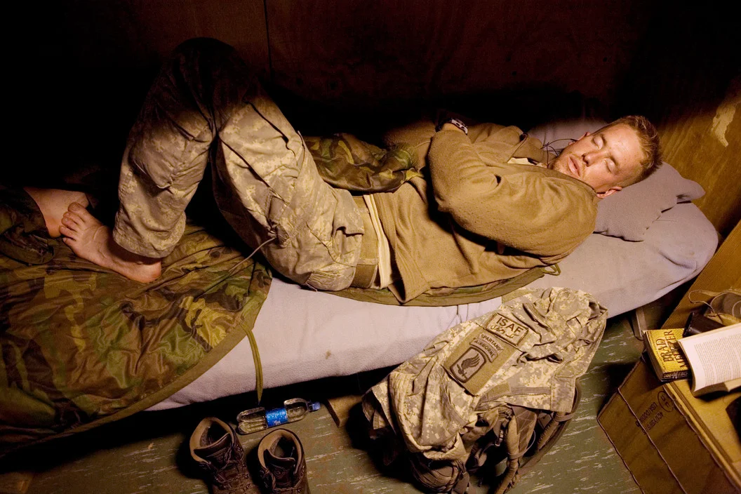 Specialist Luke Nevala sleeping in Korengal Valley, Kunar Province of Afghanistan. July 2008. Courtesy of the Tim Hetherington Trust. 