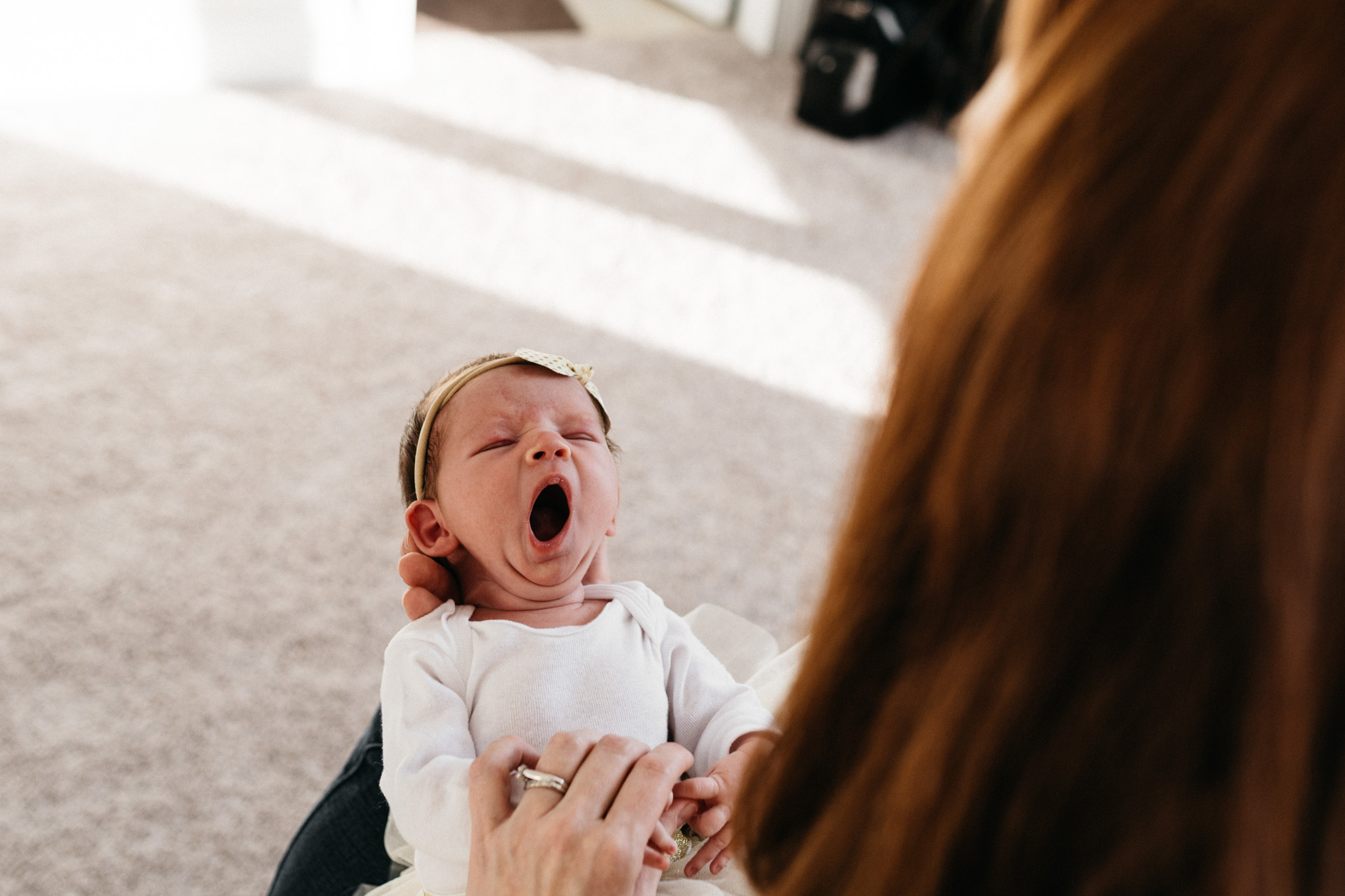 Mother-holding-newborn-daughter-yawning-Columbus-Ohio-Photographer-Erika-Venci-Photography