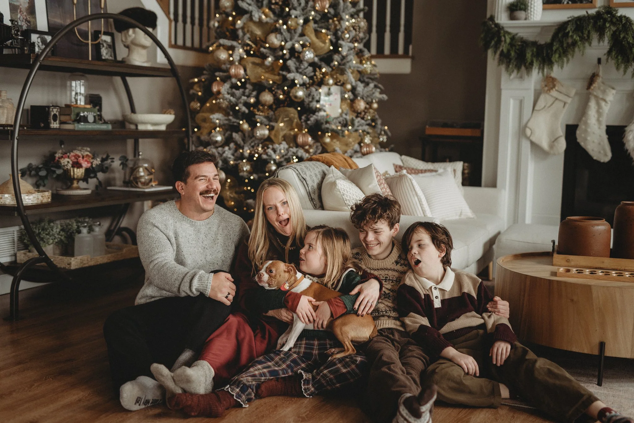 Family sitting in front of their Christmas tree in Lewis Center, Ohio
