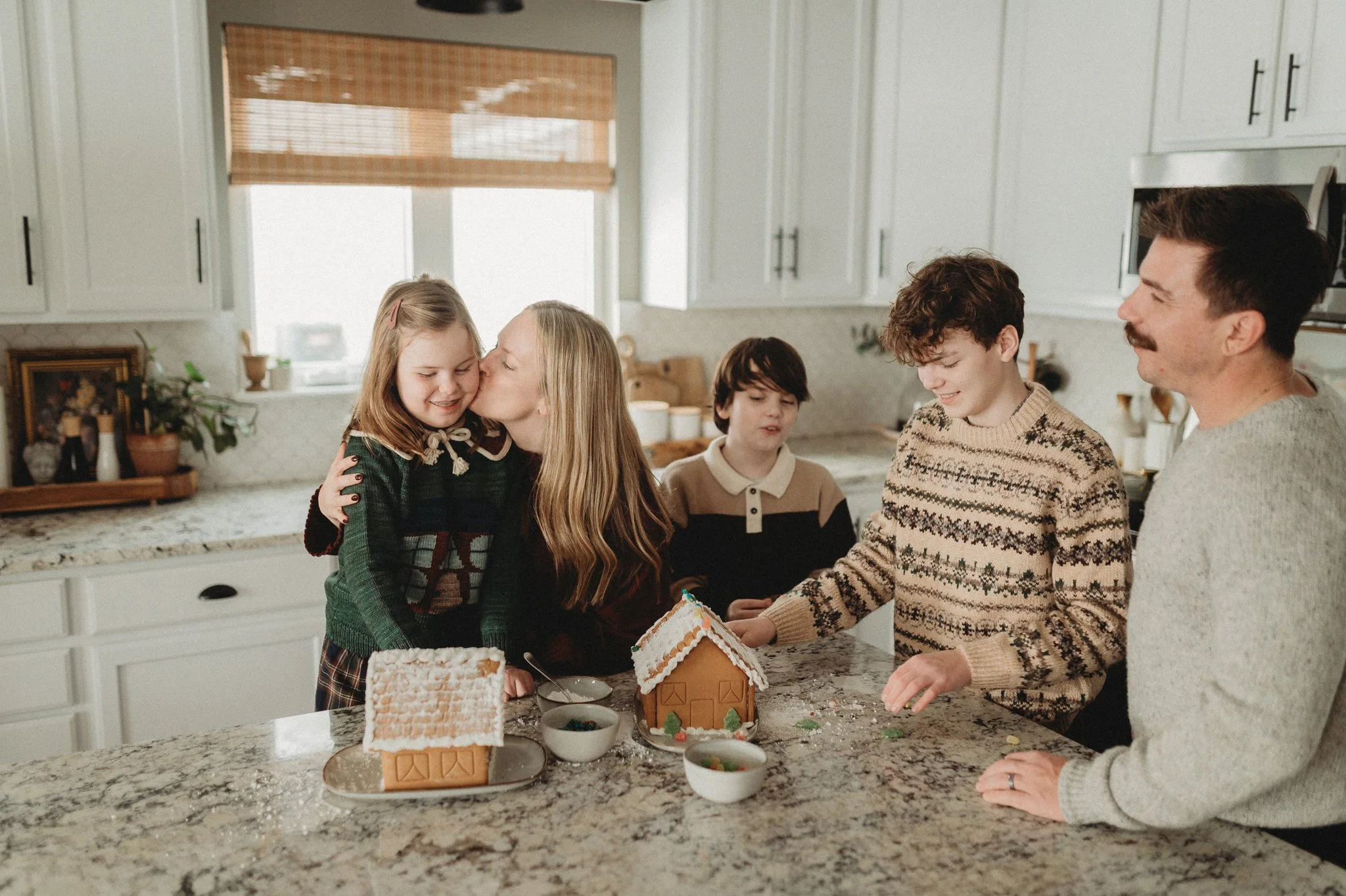 Mother and daughter decorating gingerbread houses