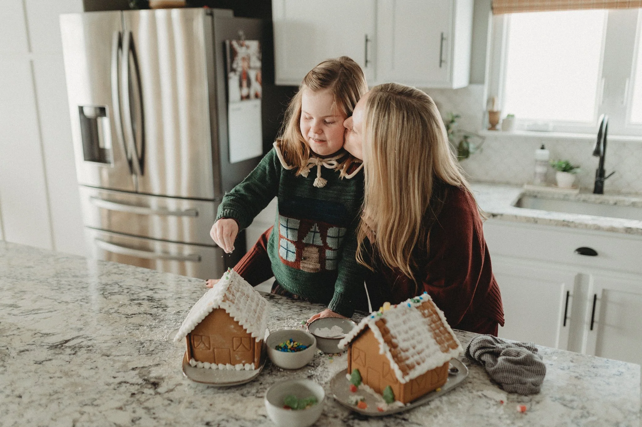 Mother and daughter decorating gingerbread houses
