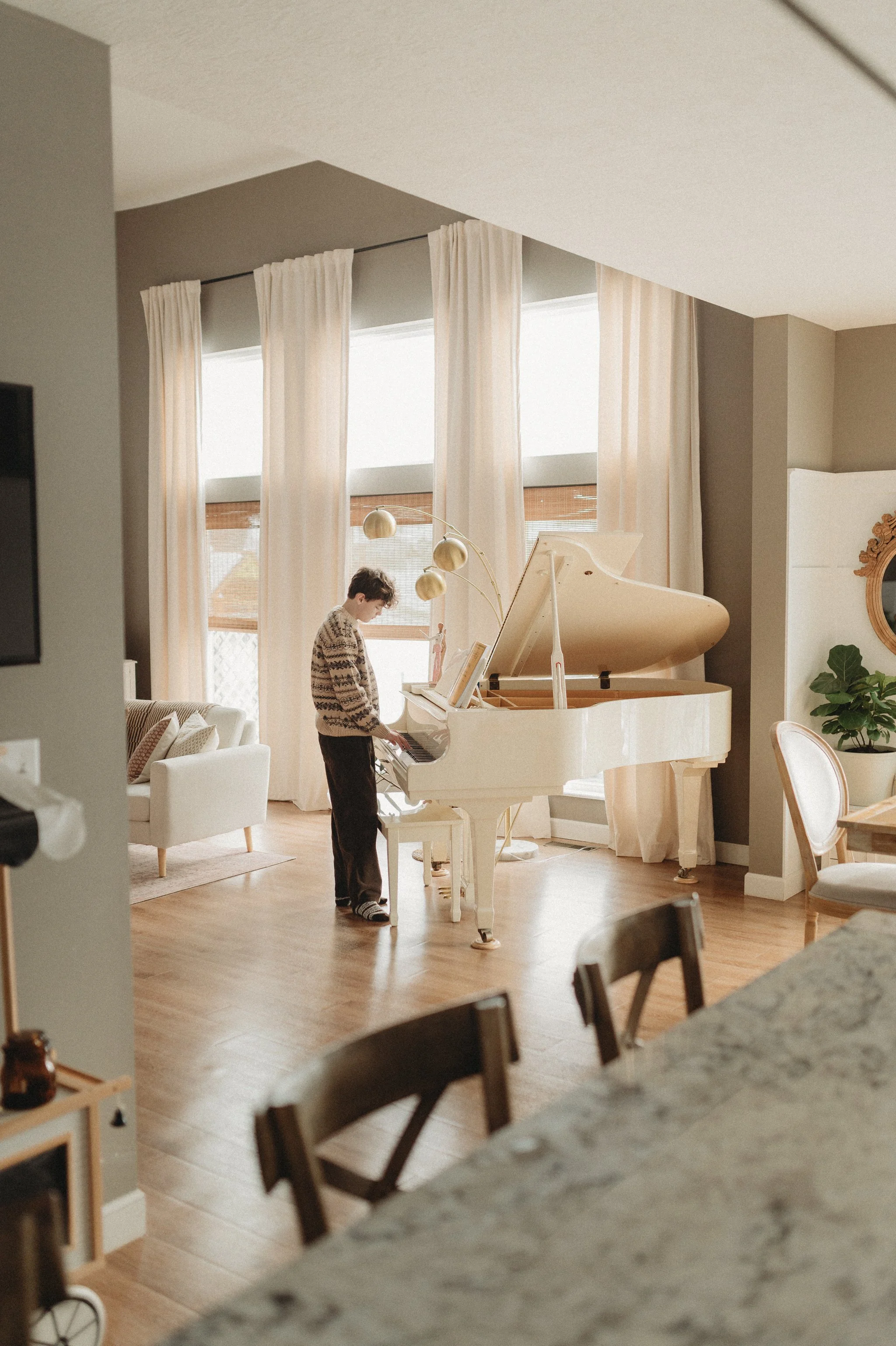 Boy Playing Piano during in-home family photos near Columbus, Ohio