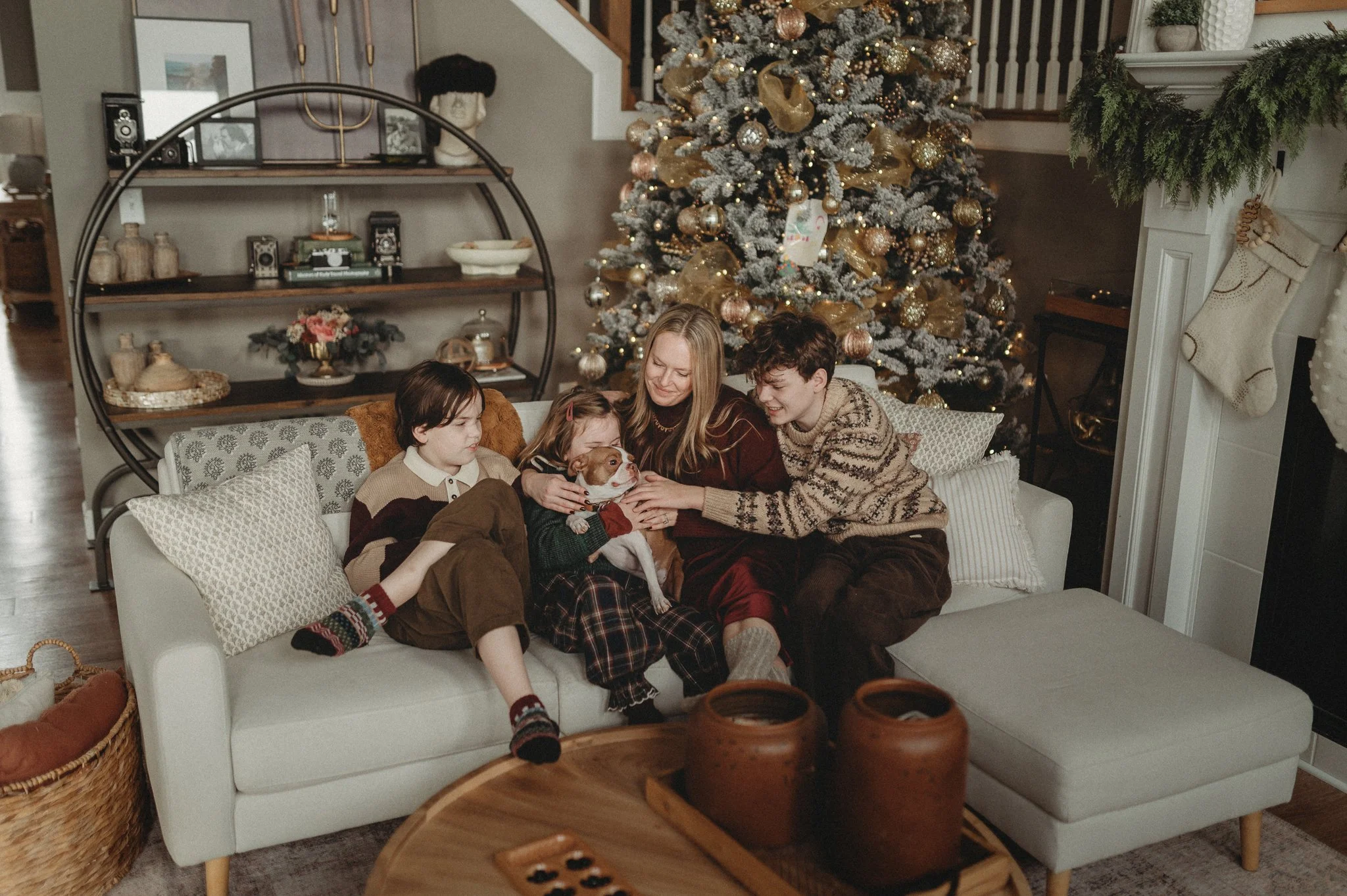 Mother cuddling on the couch with her children