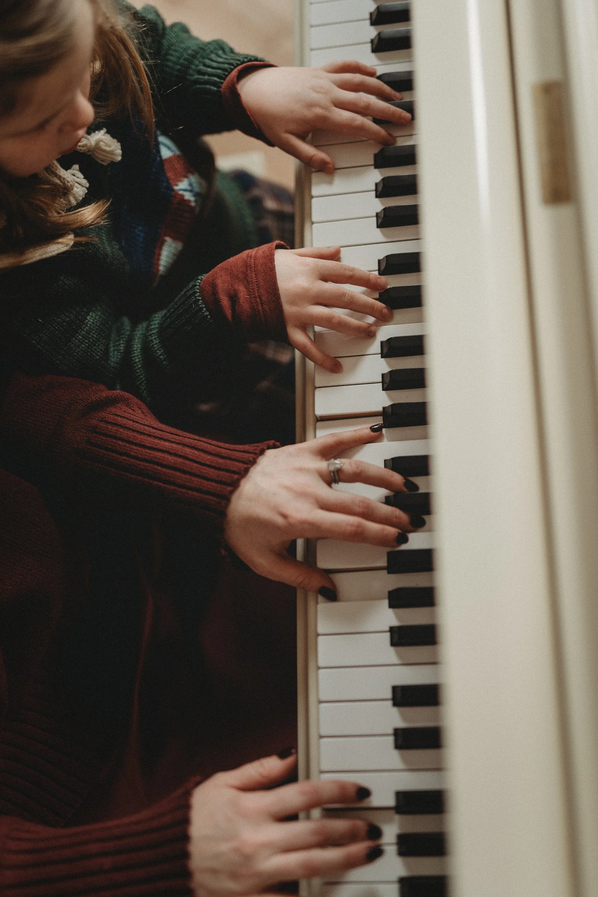 Close Up of Mother and Daughter Playing Piano 