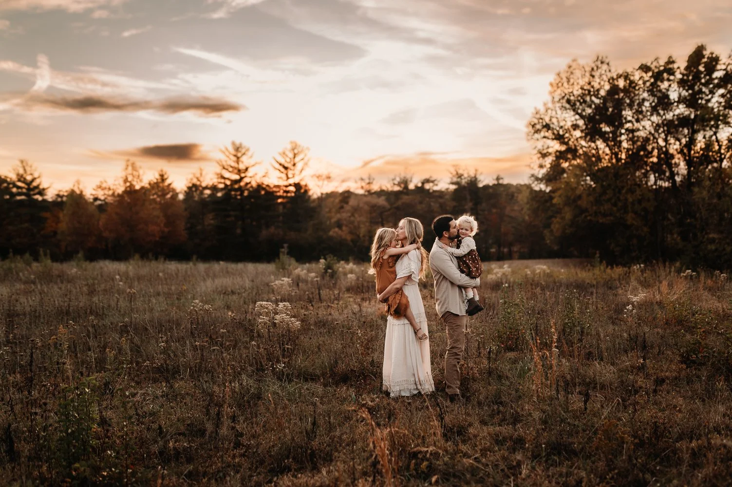 Family standing in a golden autumn field at sunset in Lewis Center Ohio