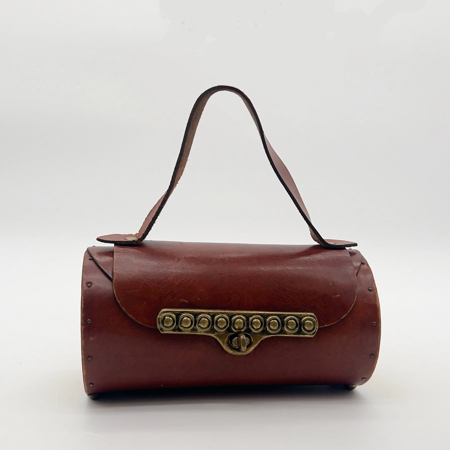  Leather and brass cylinder handbag by Enid Collins, ca late 1940s to early 1950s 