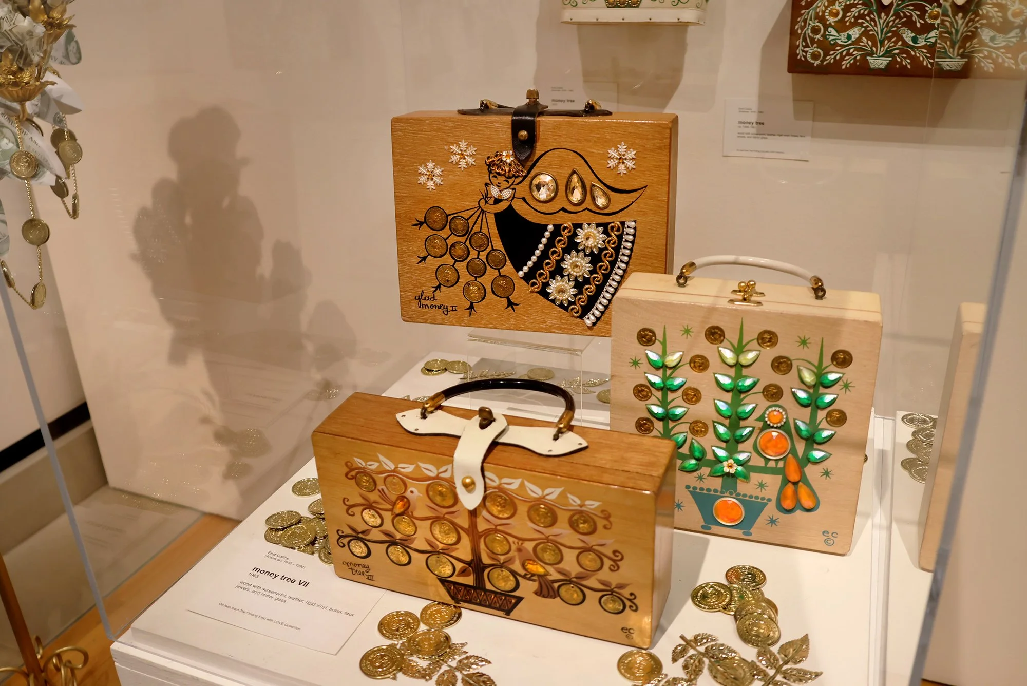  Money bags (clockwise from top): “glad money II” box bag (1964), “money tree” box bag (1967) and “money tree VII” (1963). 