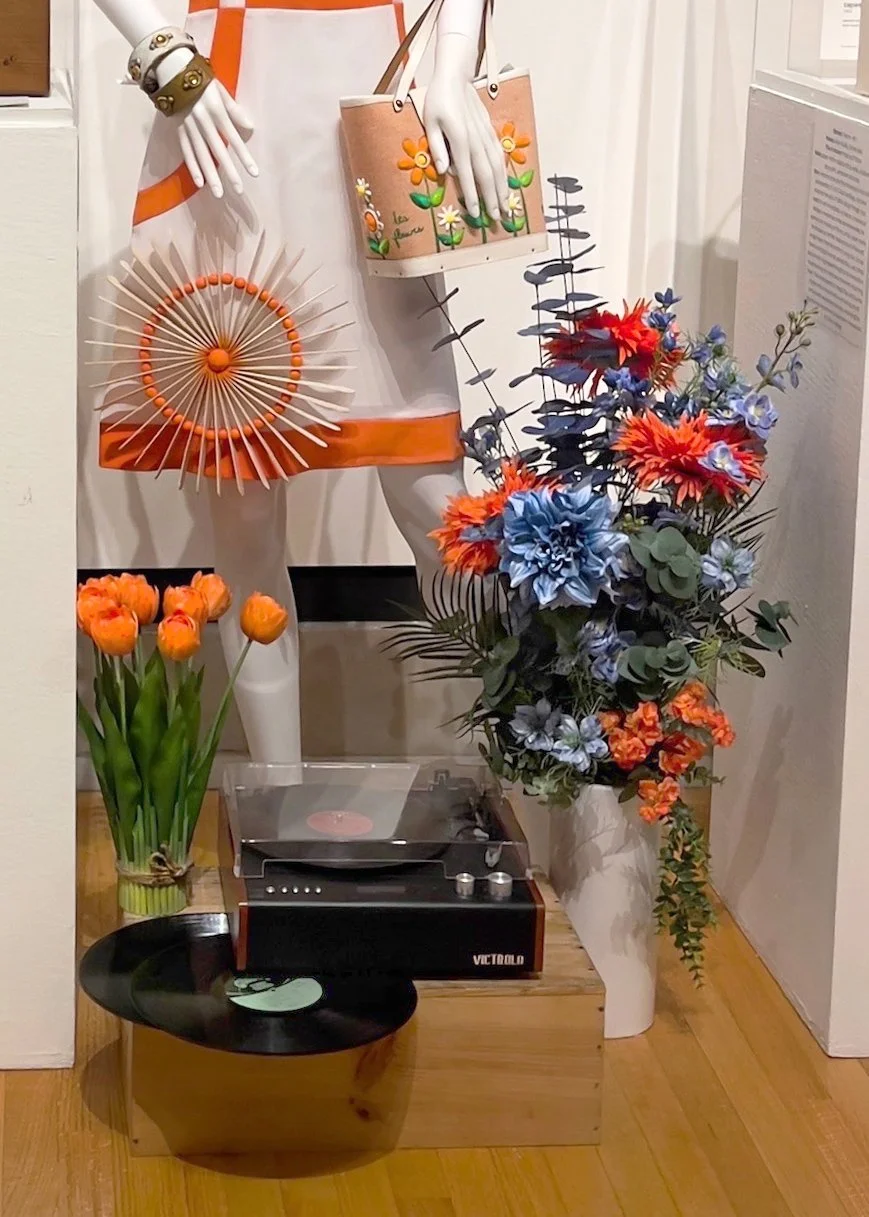  Circular forms consisting of records, painted discs, and crafted Popsicle-stick rings repeat throughout the composition, visually   echoing the rhythm and movement of spinning music .  