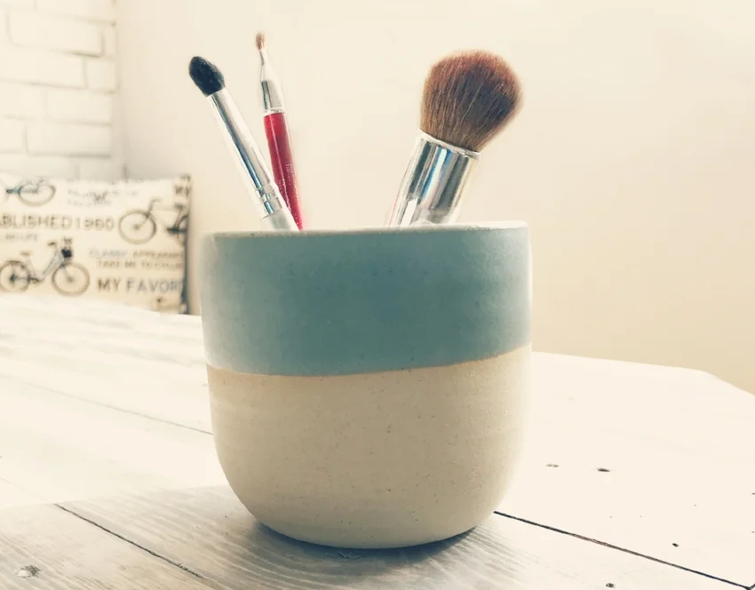 SeaLuxe customer Molly L shows off her makeup brush holder/cleaning bowl. Molly said she loved the ceramic candle holder so much, she repurposed it after using up the eco-soy West Coast-scented candle.