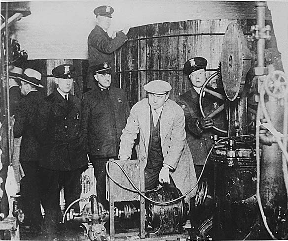 Detroit'te Prohibition dönemi sırasında bir gizli yer altı bira fabrikasında bulunan ekipmanlar inceleyen polisler...Gizli üretim yapan merdiven altı diye tabir edilen bu yerlerin sayısının 1927ler'de 100.000 ler civarını ulaştığı söylenir...