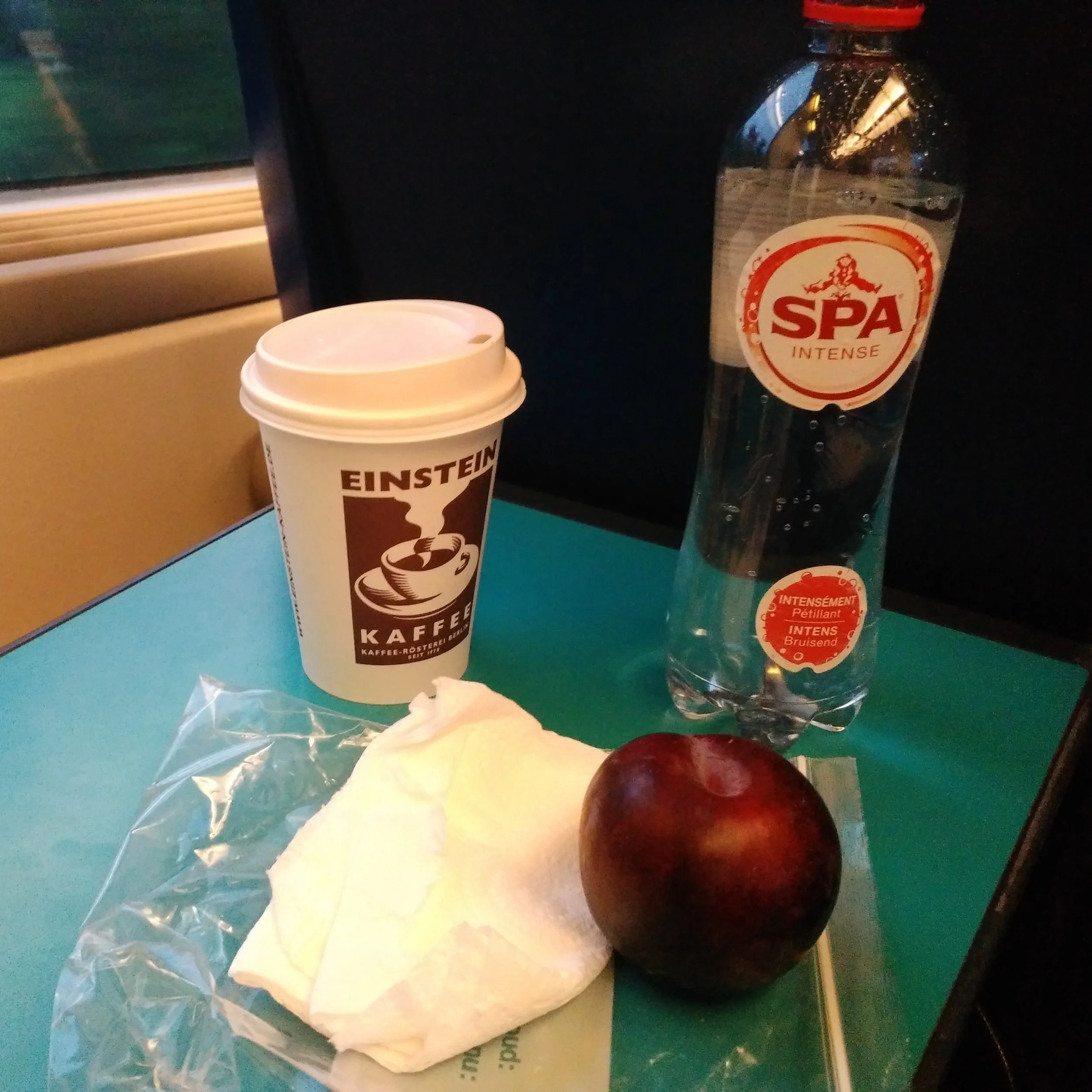 Took a piece of fruit from home and grabbed a soy latte and sparkling water at the train station. Ate most of it on the train to the Brussels Airport. It was a shockingly bad latte.
